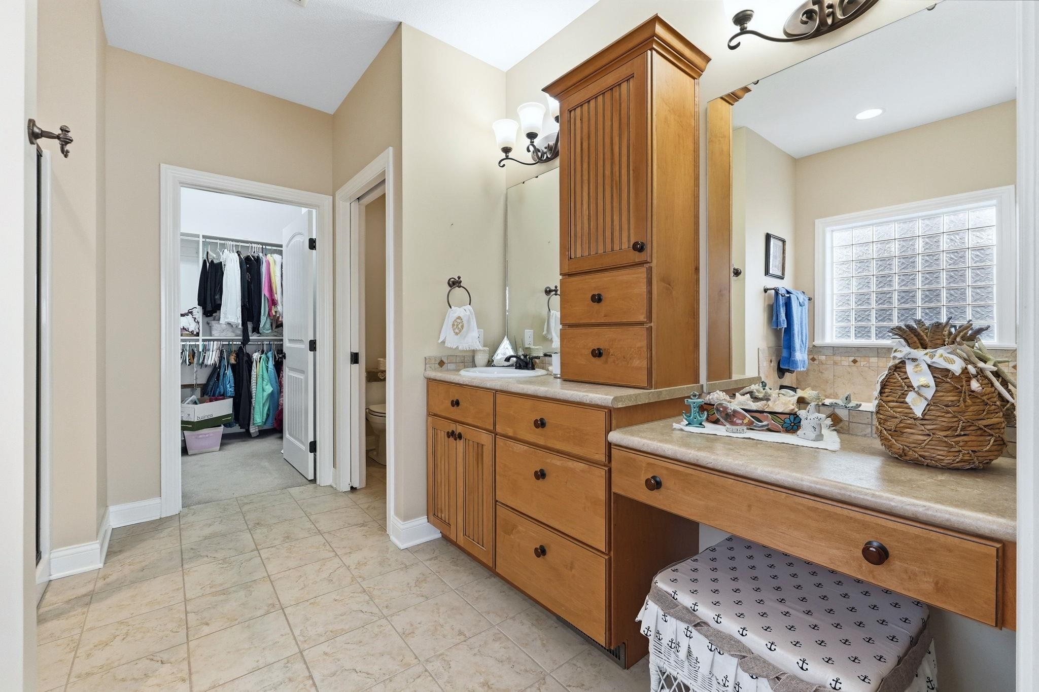 Full bath with vanity and a walk in closet