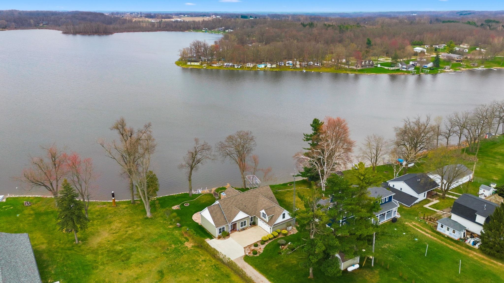 Aerial view of residential area featuring a nearby body of water
