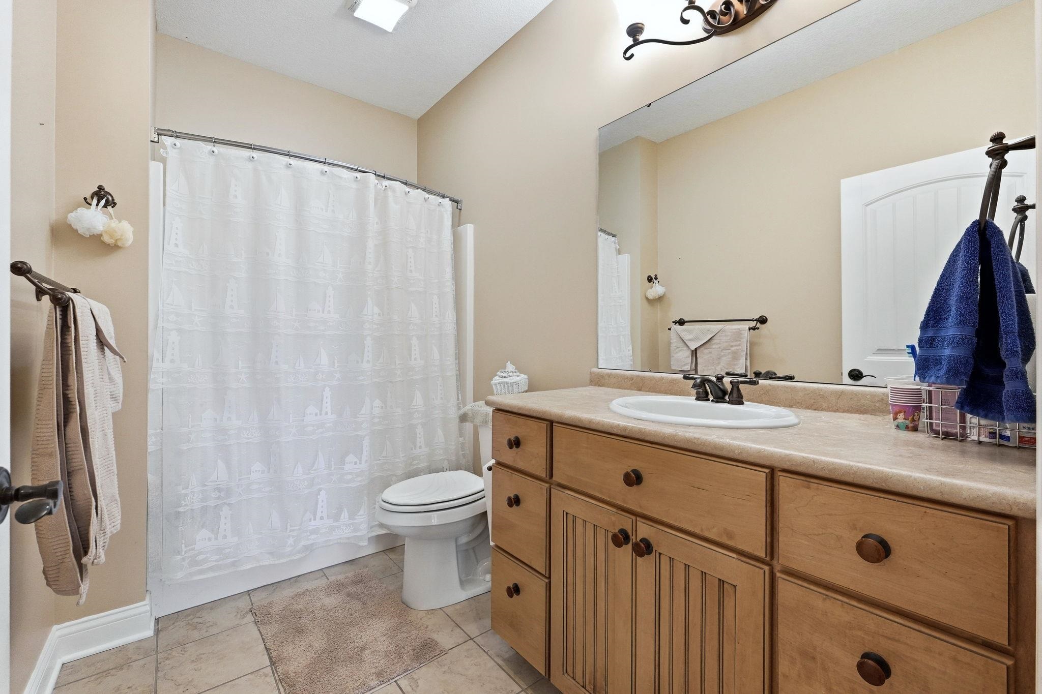 Bathroom featuring vanity and light tile patterned floors