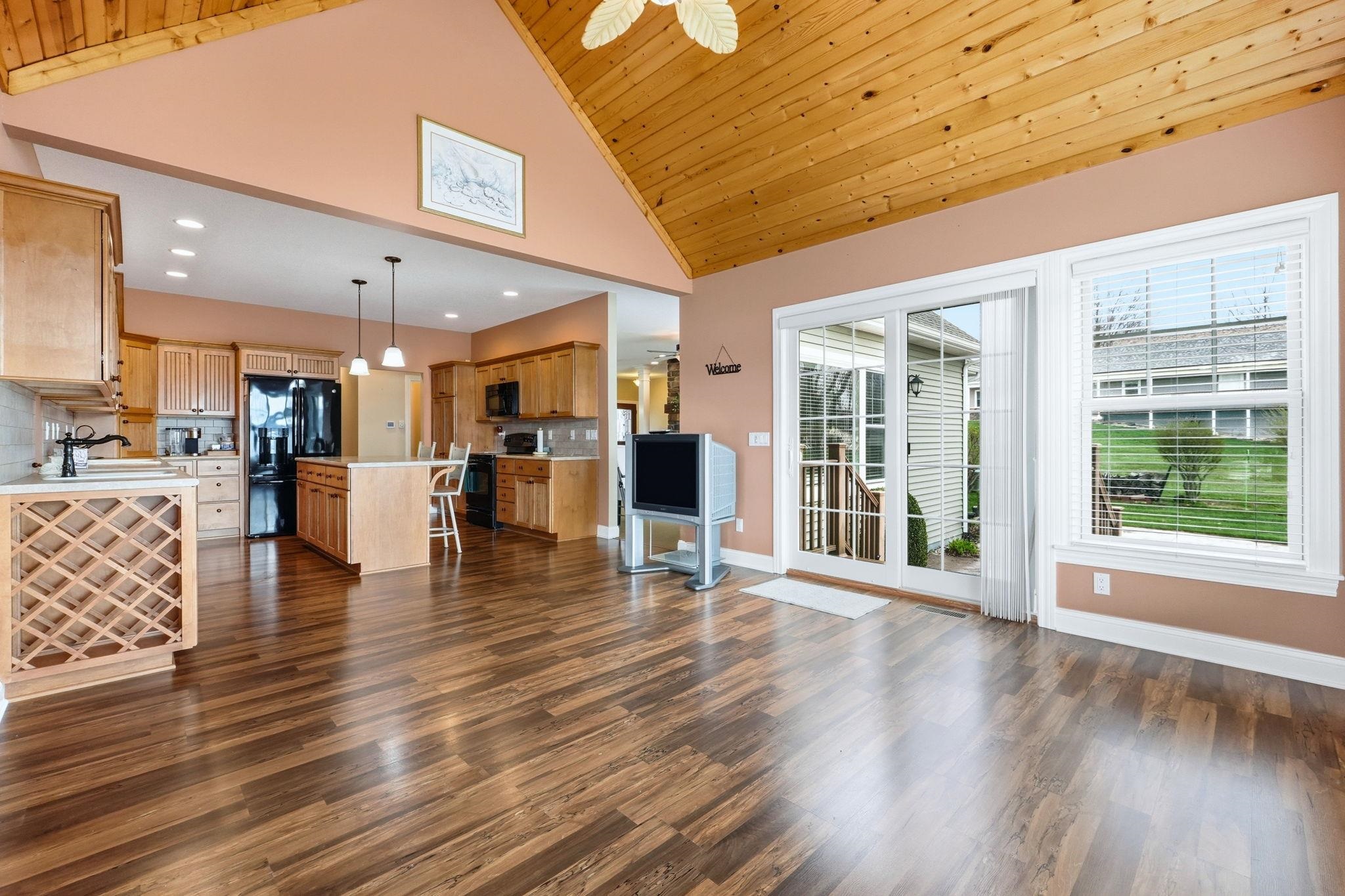 Living room featuring dark wood-style flooring, a vaulted wooden ceiling, recessed lighting, and ceiling fan