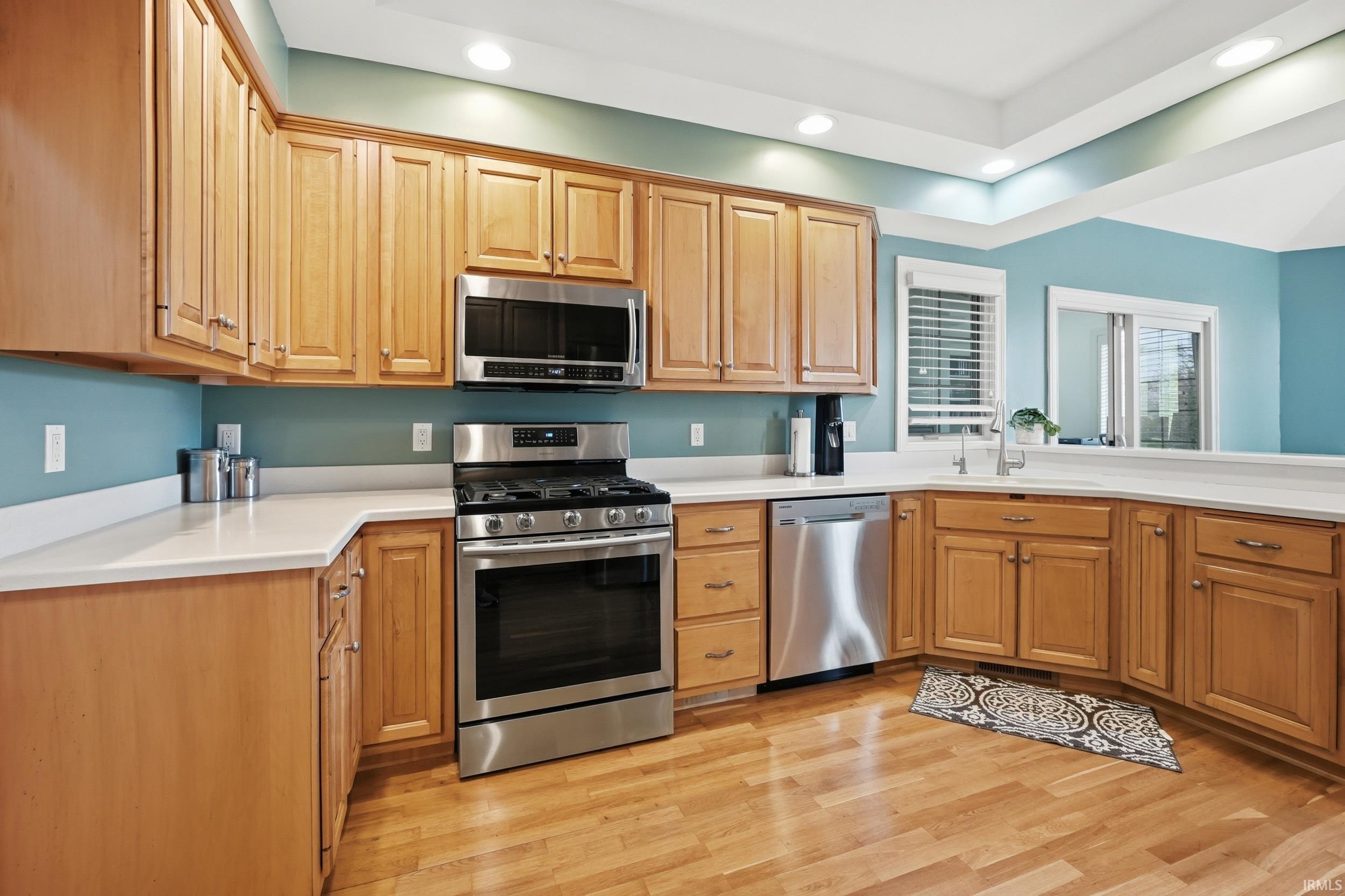 Kitchen with stainless steel appliances, recessed lighting, and light wood-type flooring