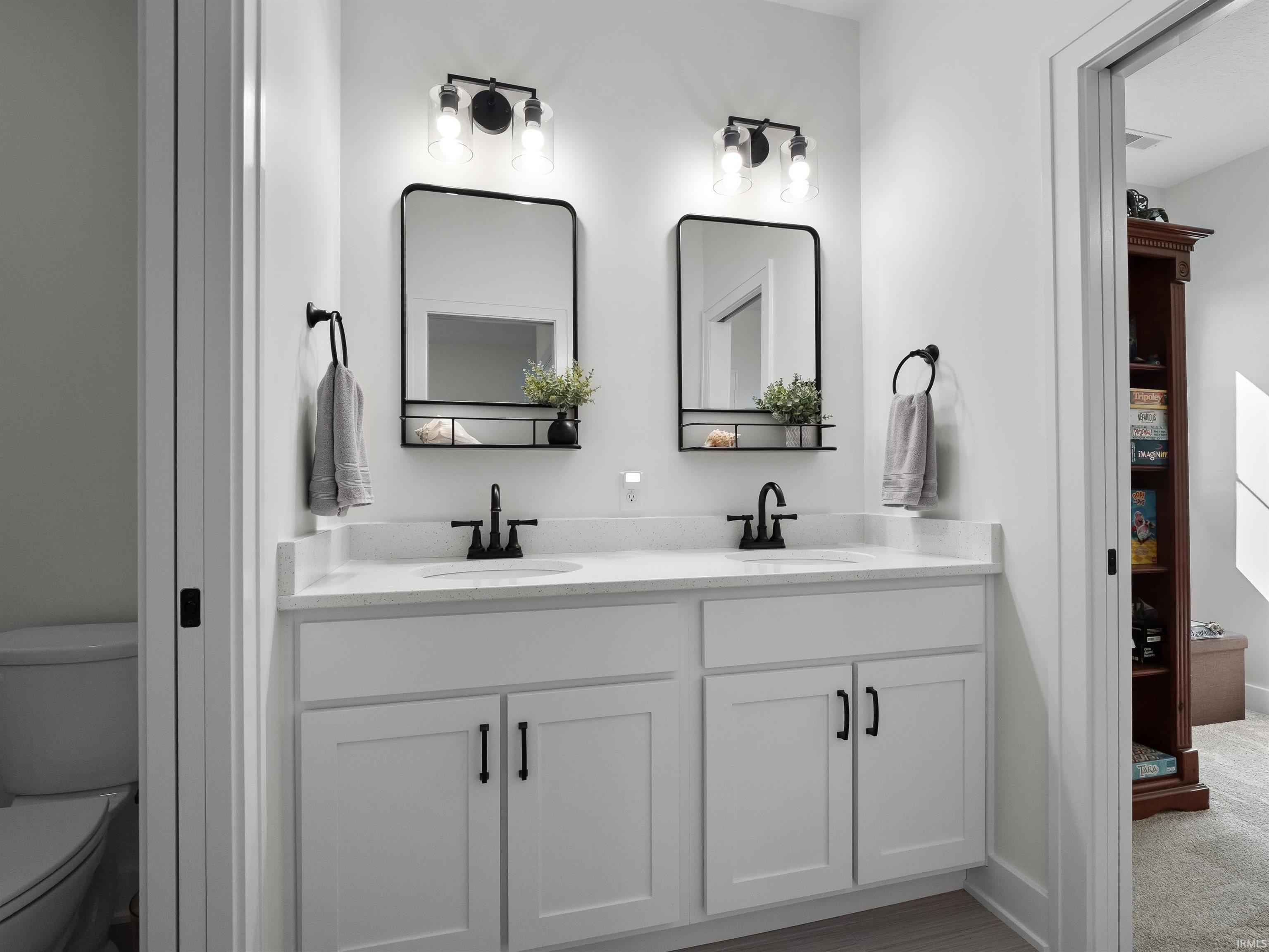 Bathroom featuring double vanity and toilet