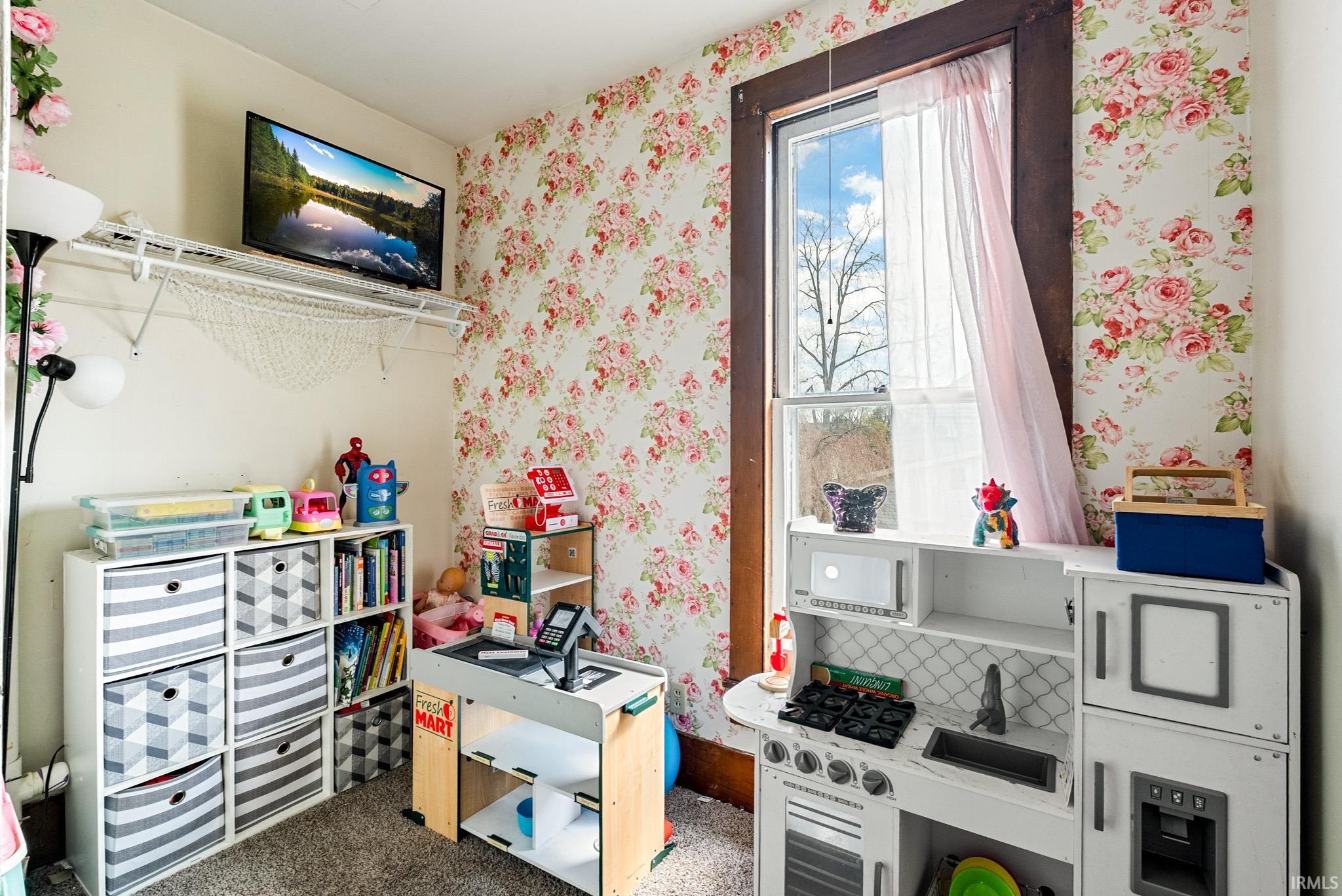 Rec room featuring wallpapered walls and carpet
