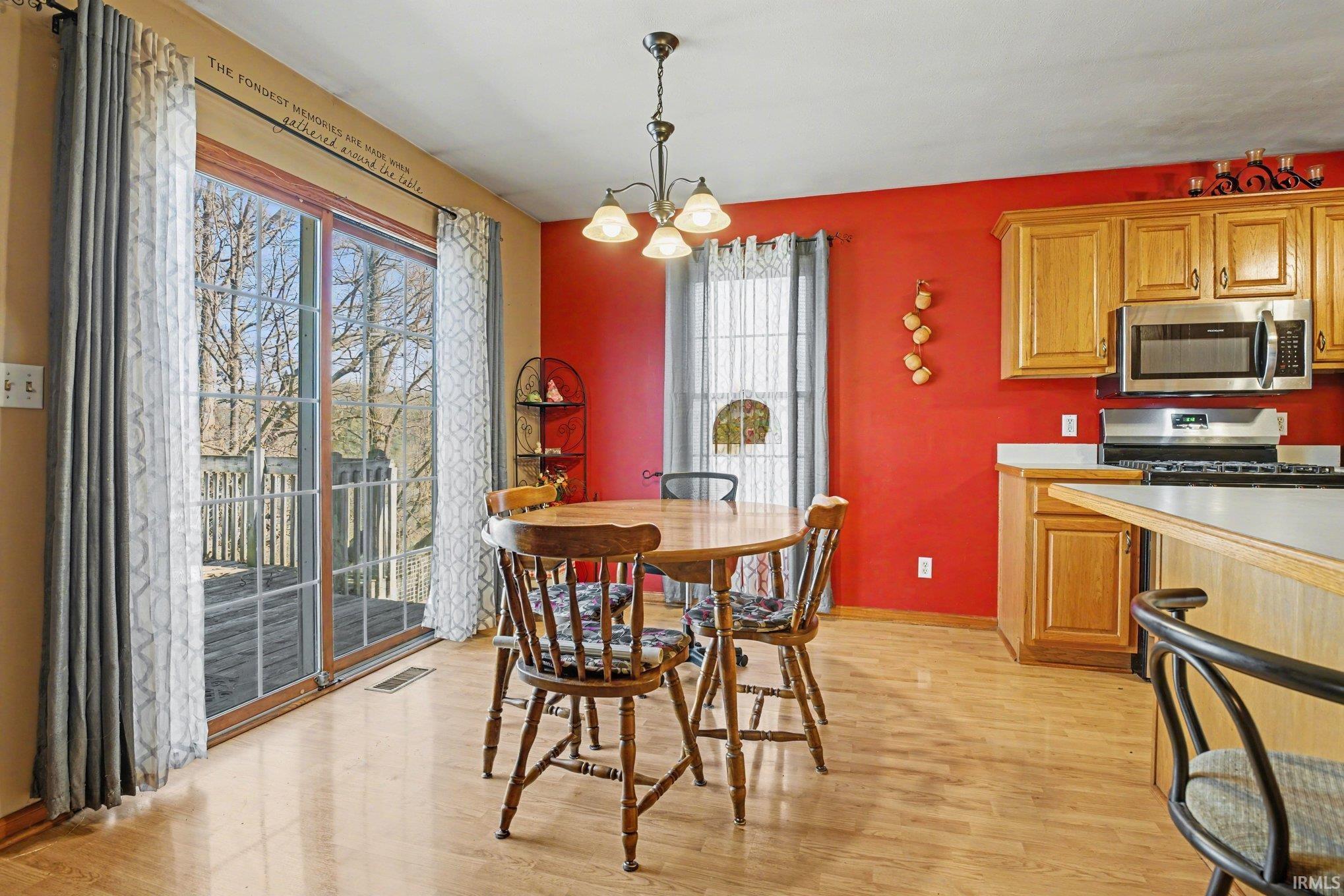 Dining space featuring a chandelier and light wood-style floors