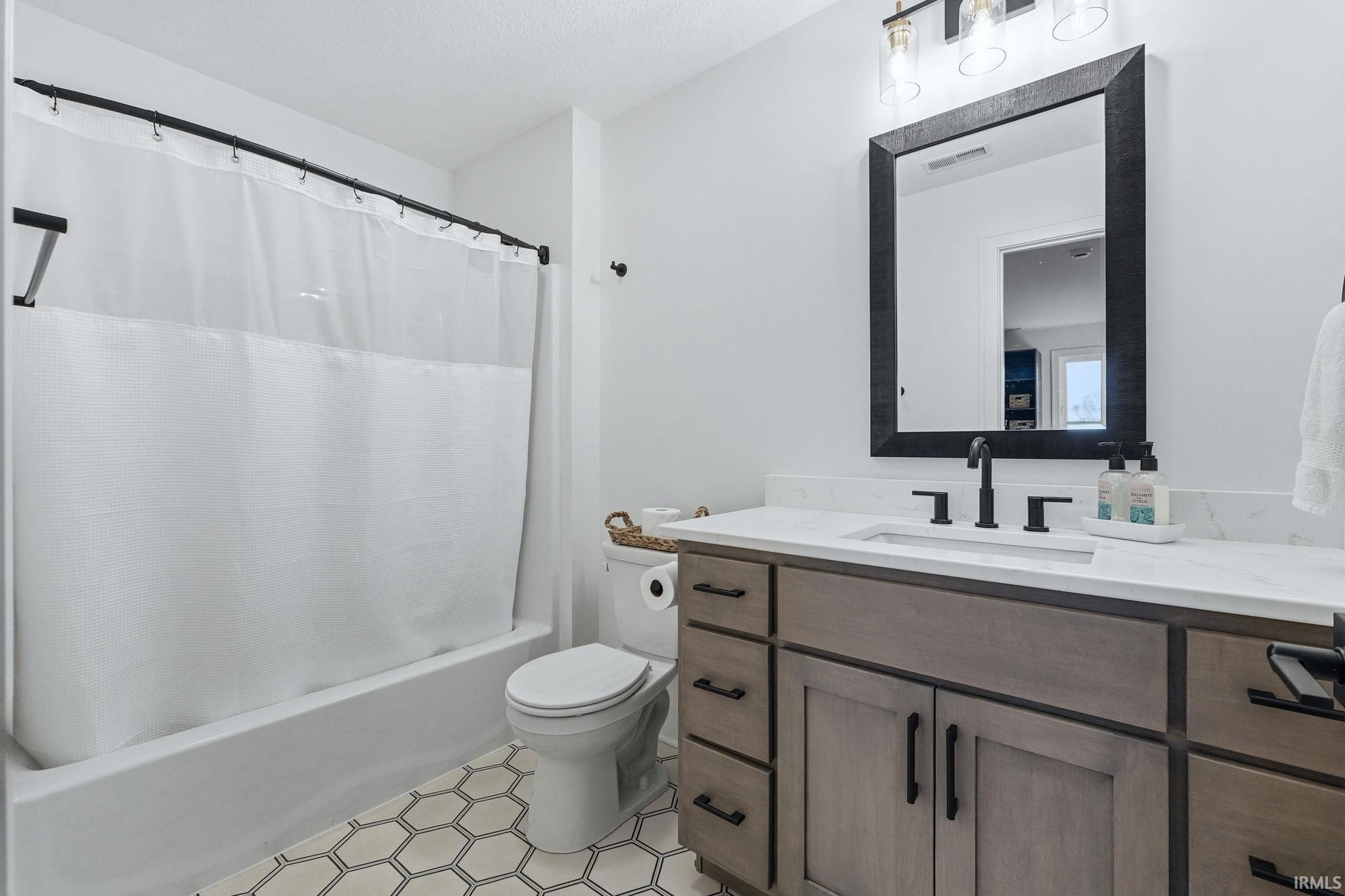 Full bathroom with vanity and shower / tub combo with curtain