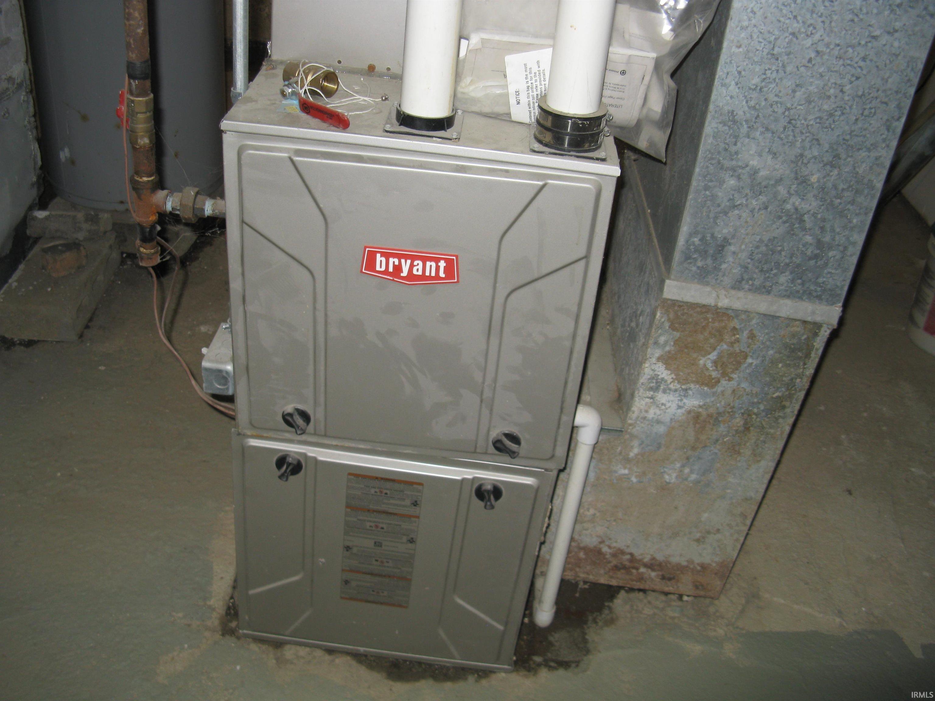 Utility room with gas water heater and heating unit
