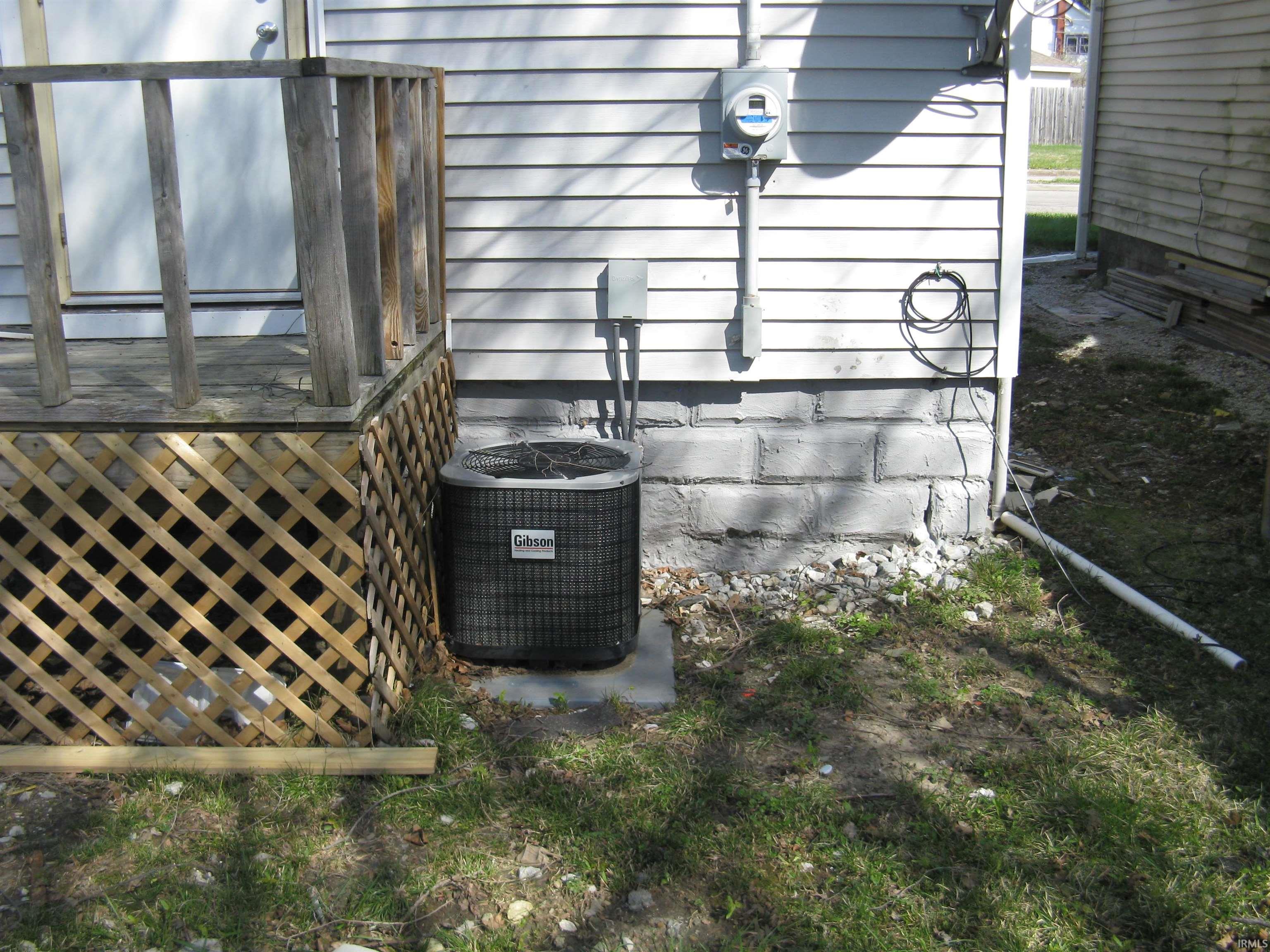 Exterior view of a central AC unit and electric meter