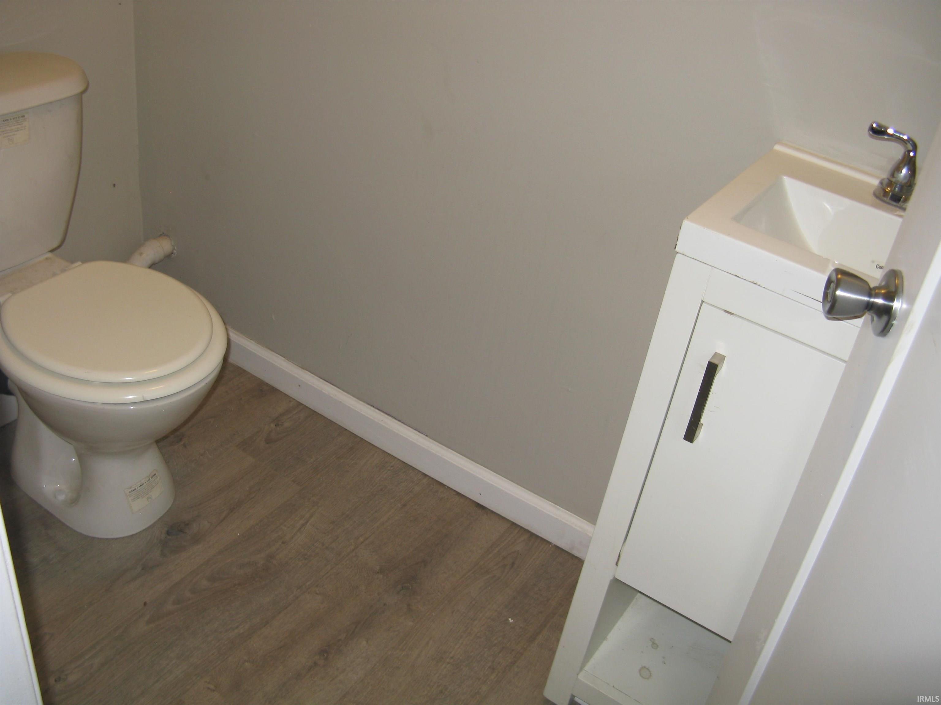Bathroom featuring vanity and wood finished floors