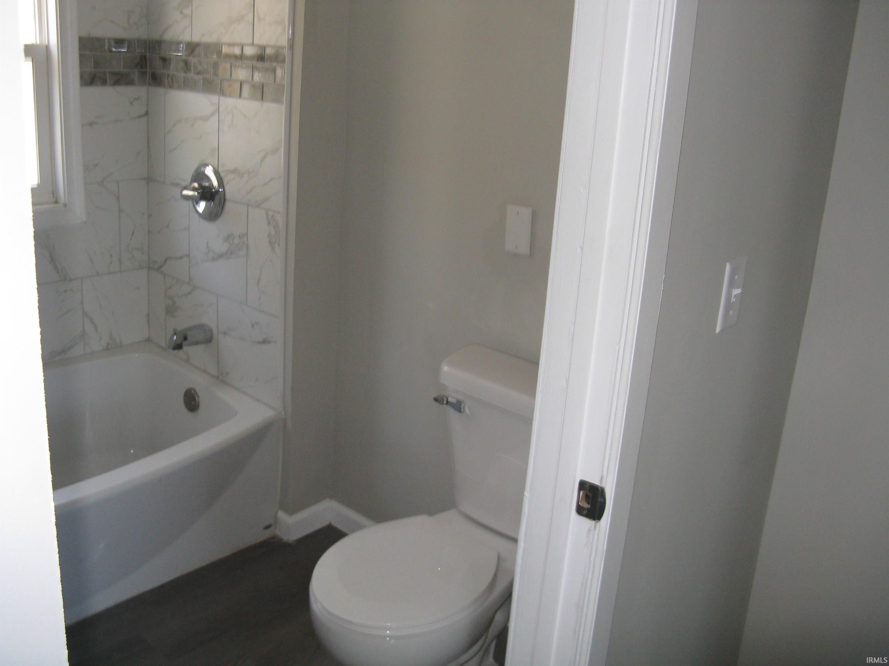 Bathroom with toilet and tub / shower combination