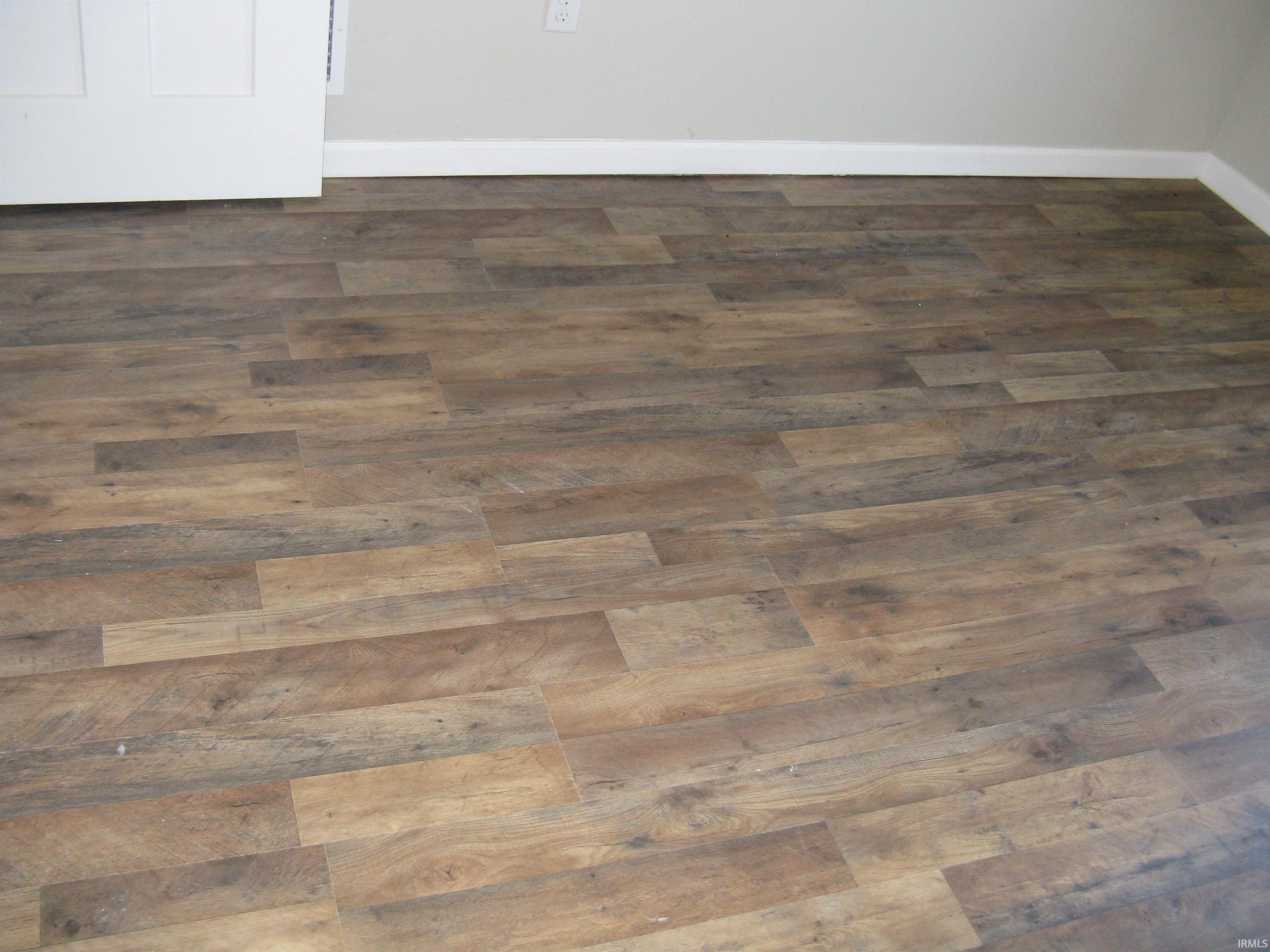 Detailed view of parquet flooring and baseboards