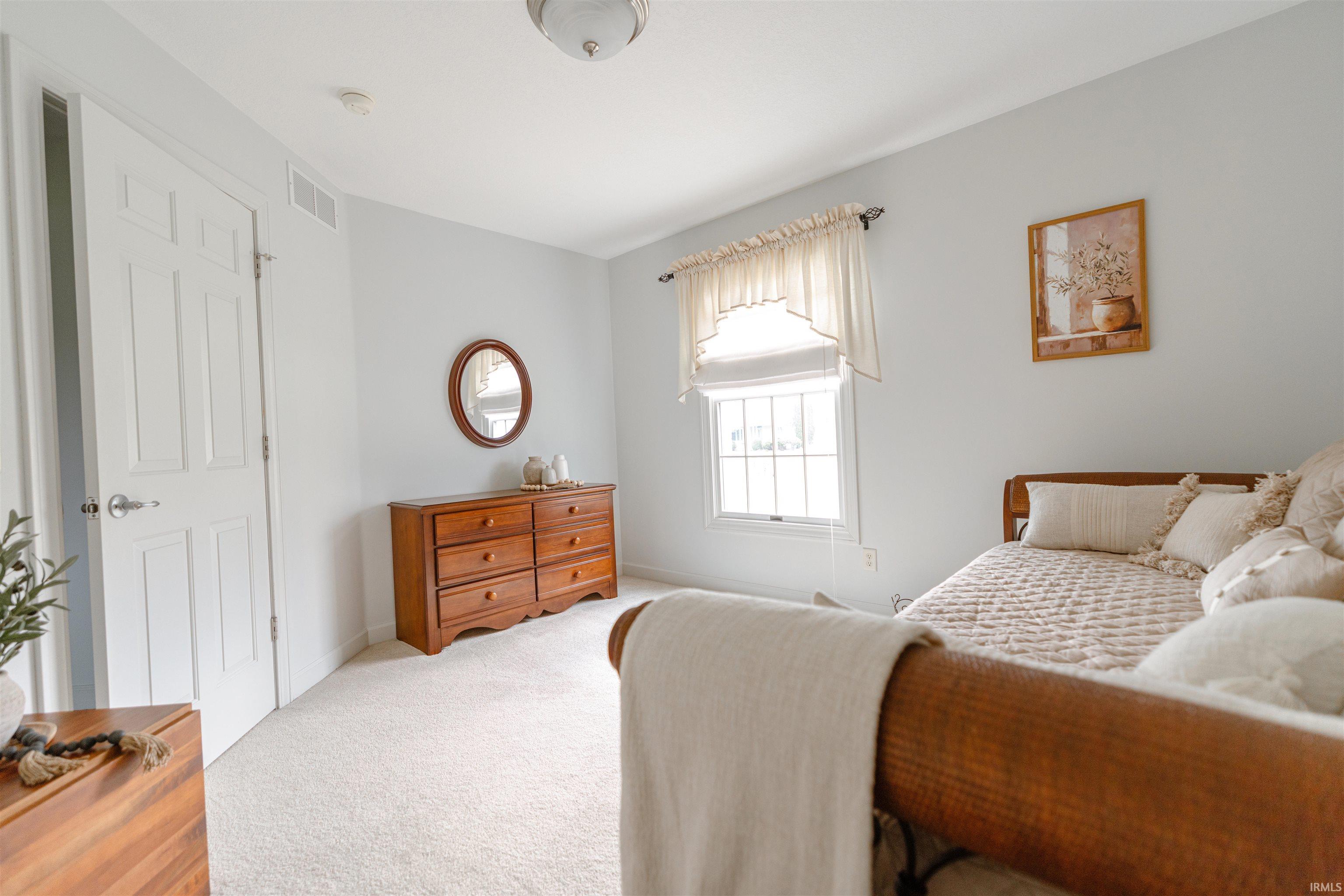 Carpeted bedroom featuring baseboards