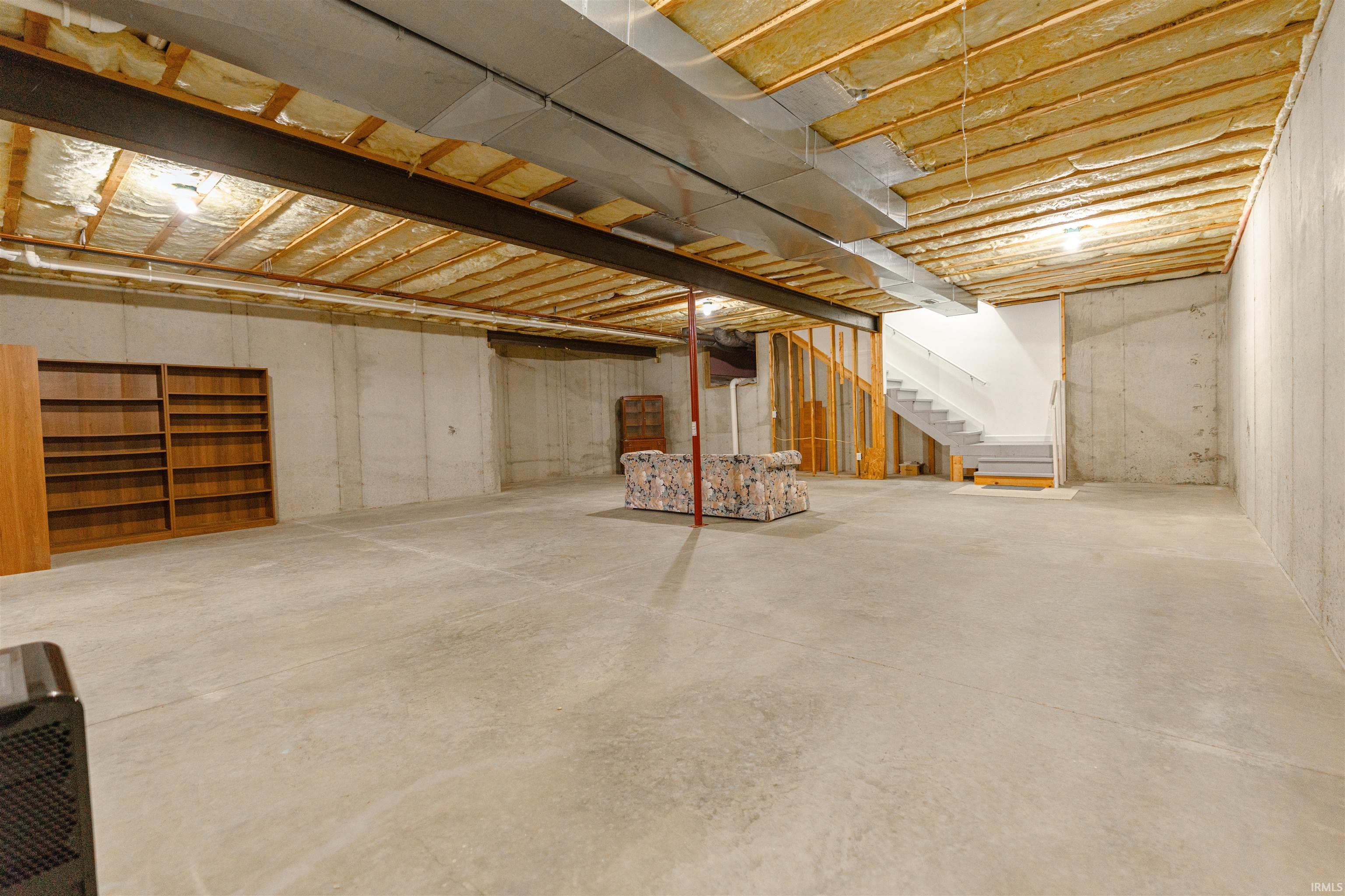 Unfinished basement featuring stairway