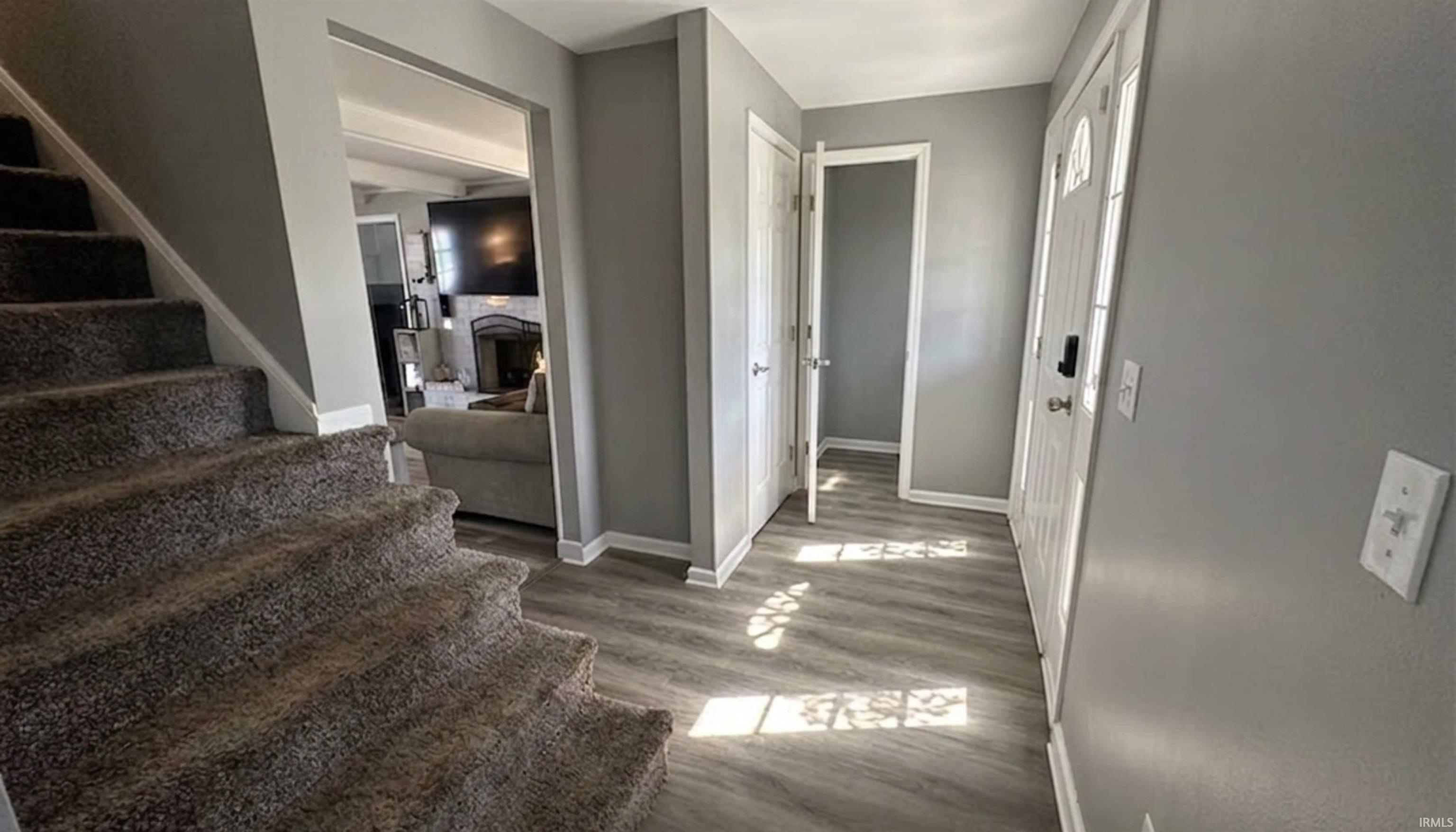 Entry way. Half bath to the left once you enter. There is a closet for storage. Enter into the living room or family room. Stairway that leads upstairs to the bedrooms and full bath.