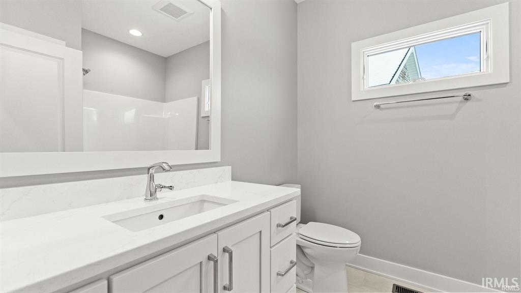 Bathroom featuring vanity and a shower