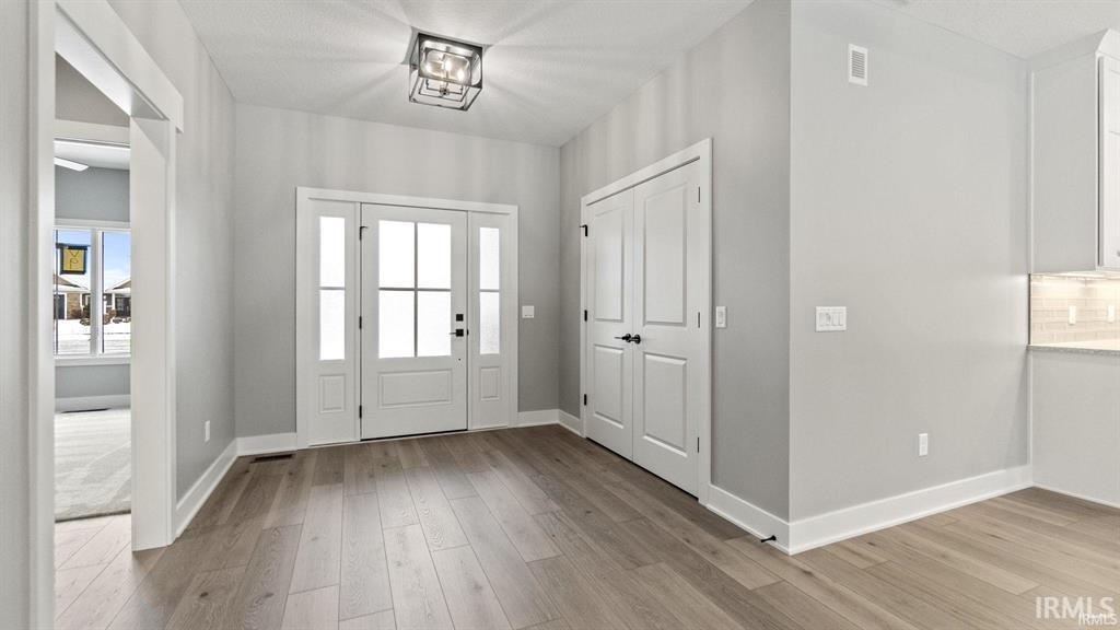 Foyer featuring healthy amount of natural light and light wood-style flooring