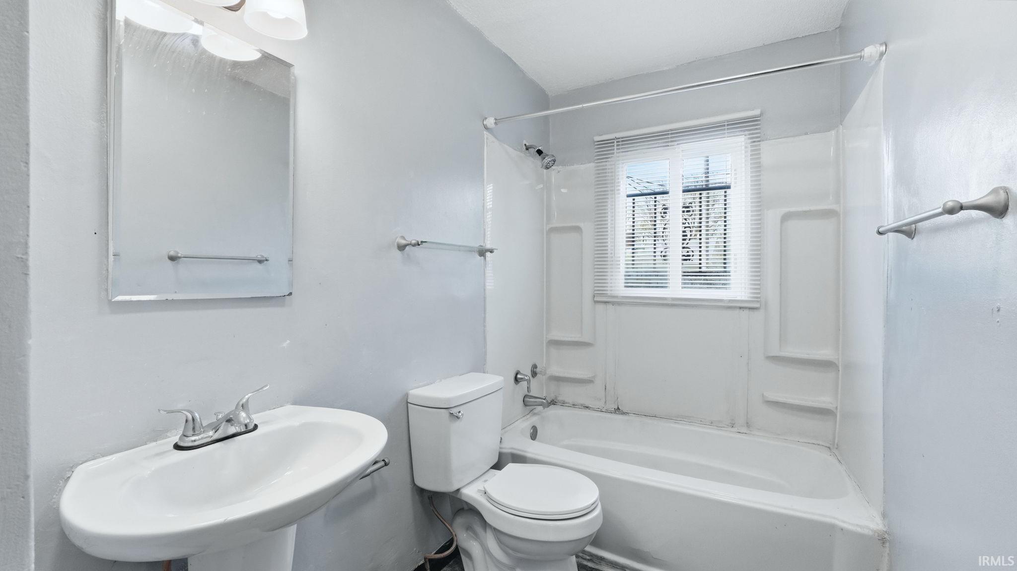 Bathroom with toilet and tub / shower combination
