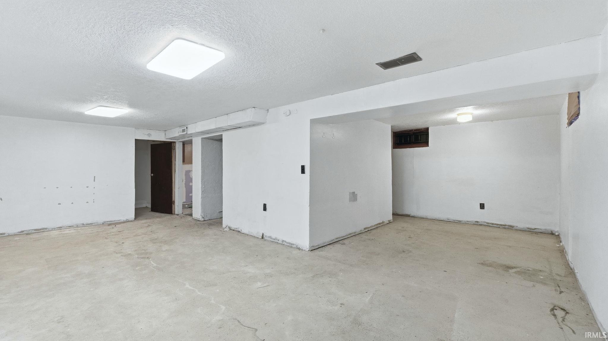 Finished below grade area featuring a textured ceiling