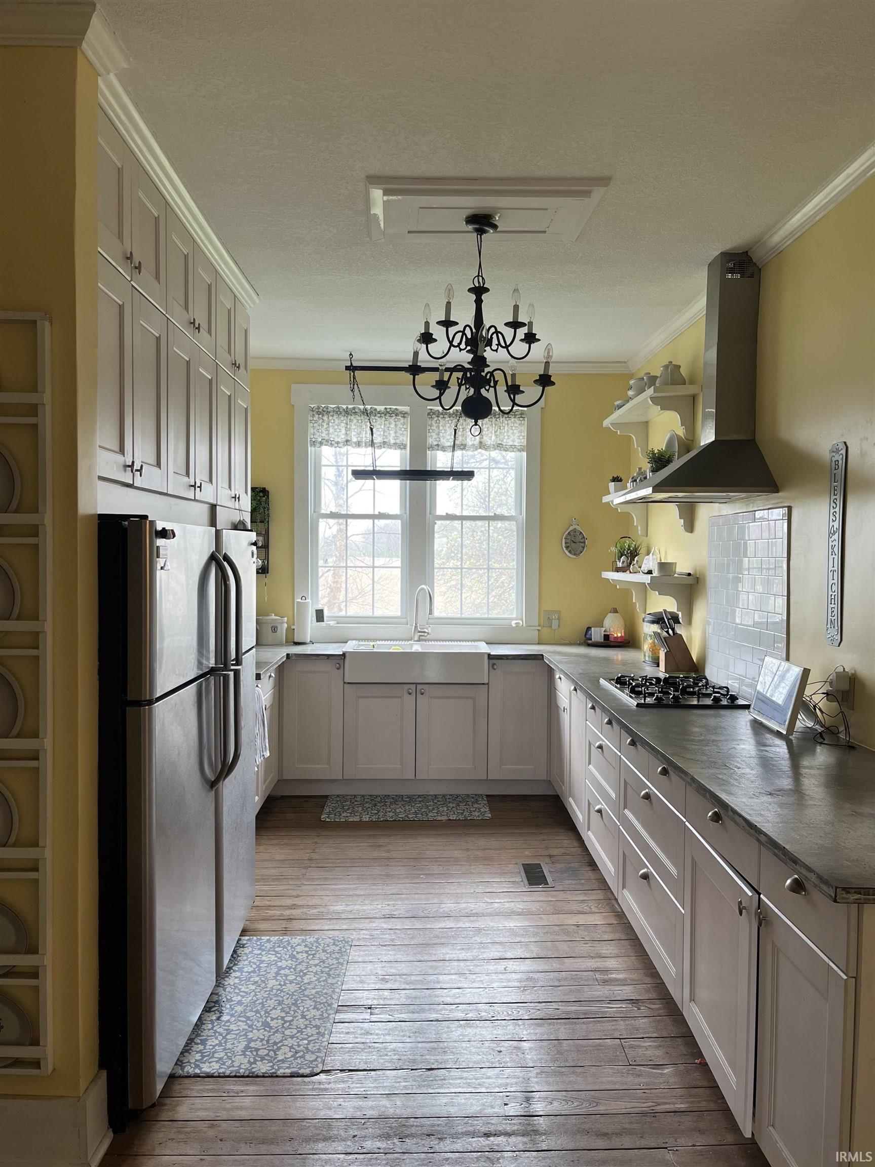 Kitchen featuring open shelves, freestanding refrigerator, crown molding, light wood-type flooring, and gas cooktop