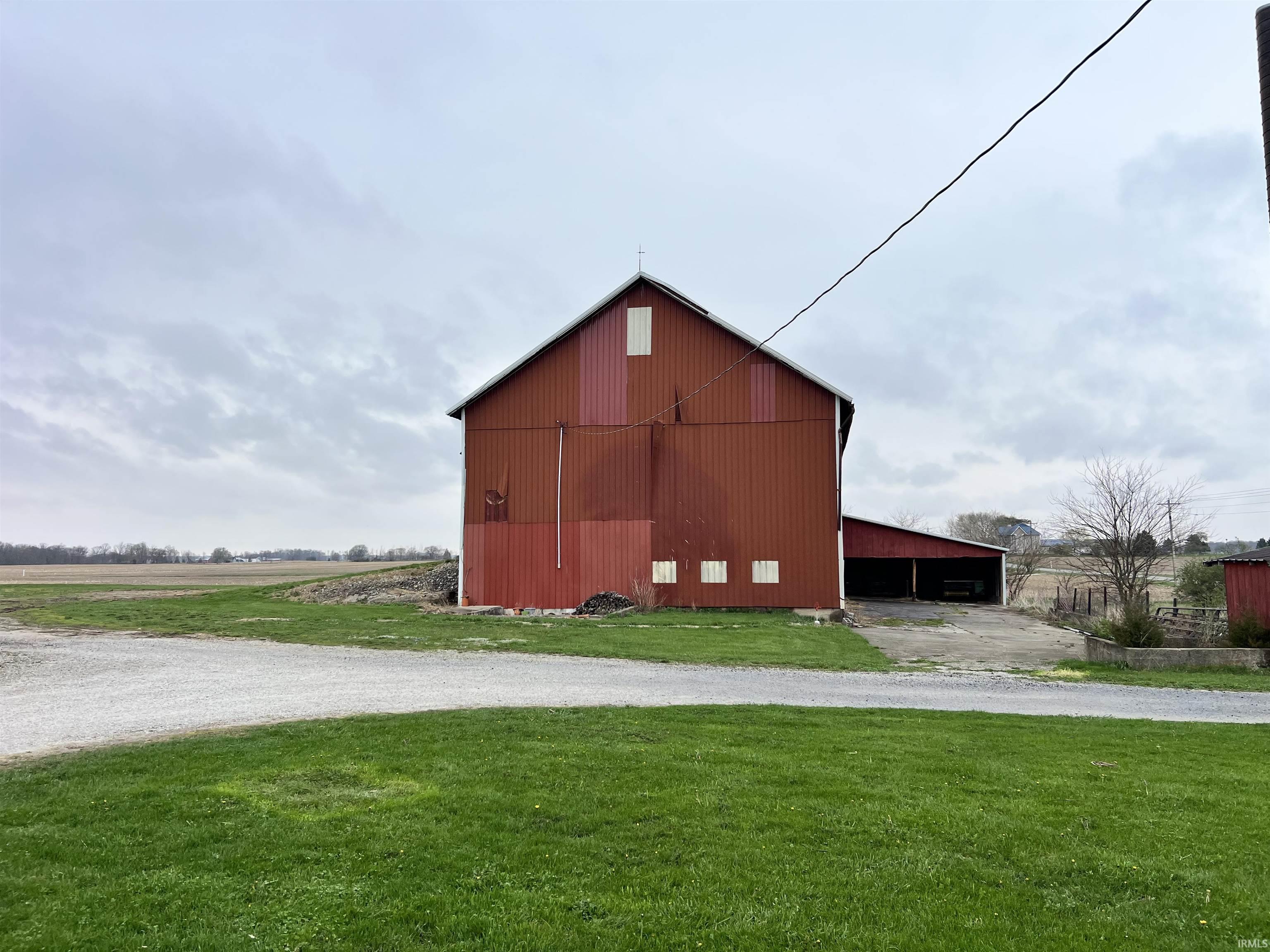 View of pole building featuring a lawn and driveway