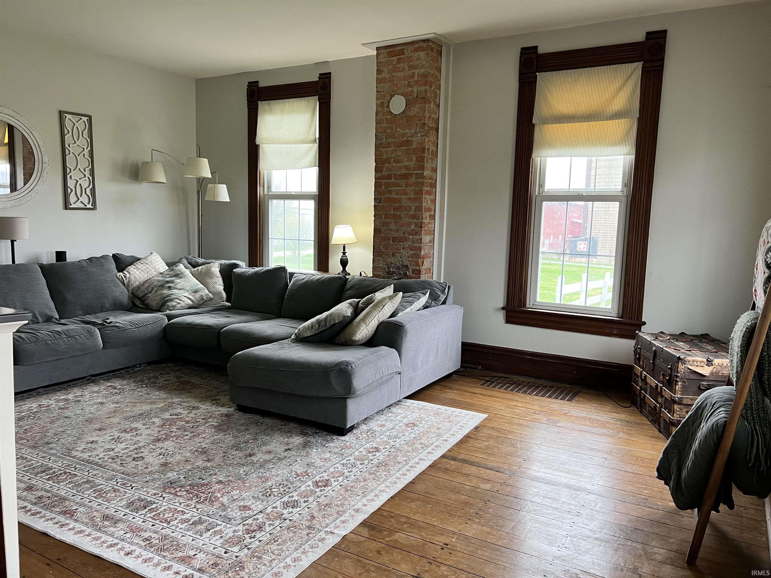 Living area with hardwood / wood-style flooring and baseboards
