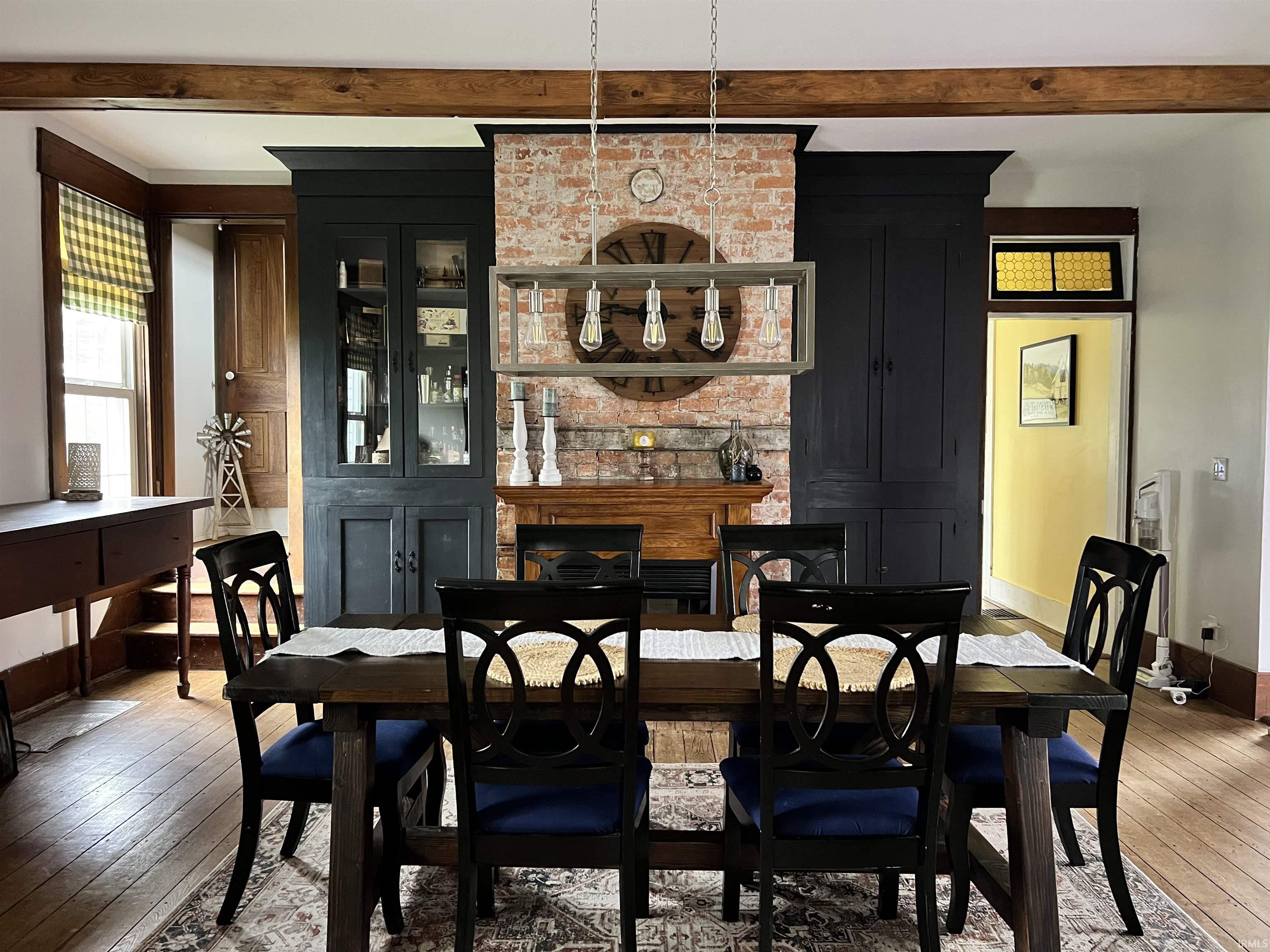 Dining space featuring light wood-type flooring and beamed ceiling
