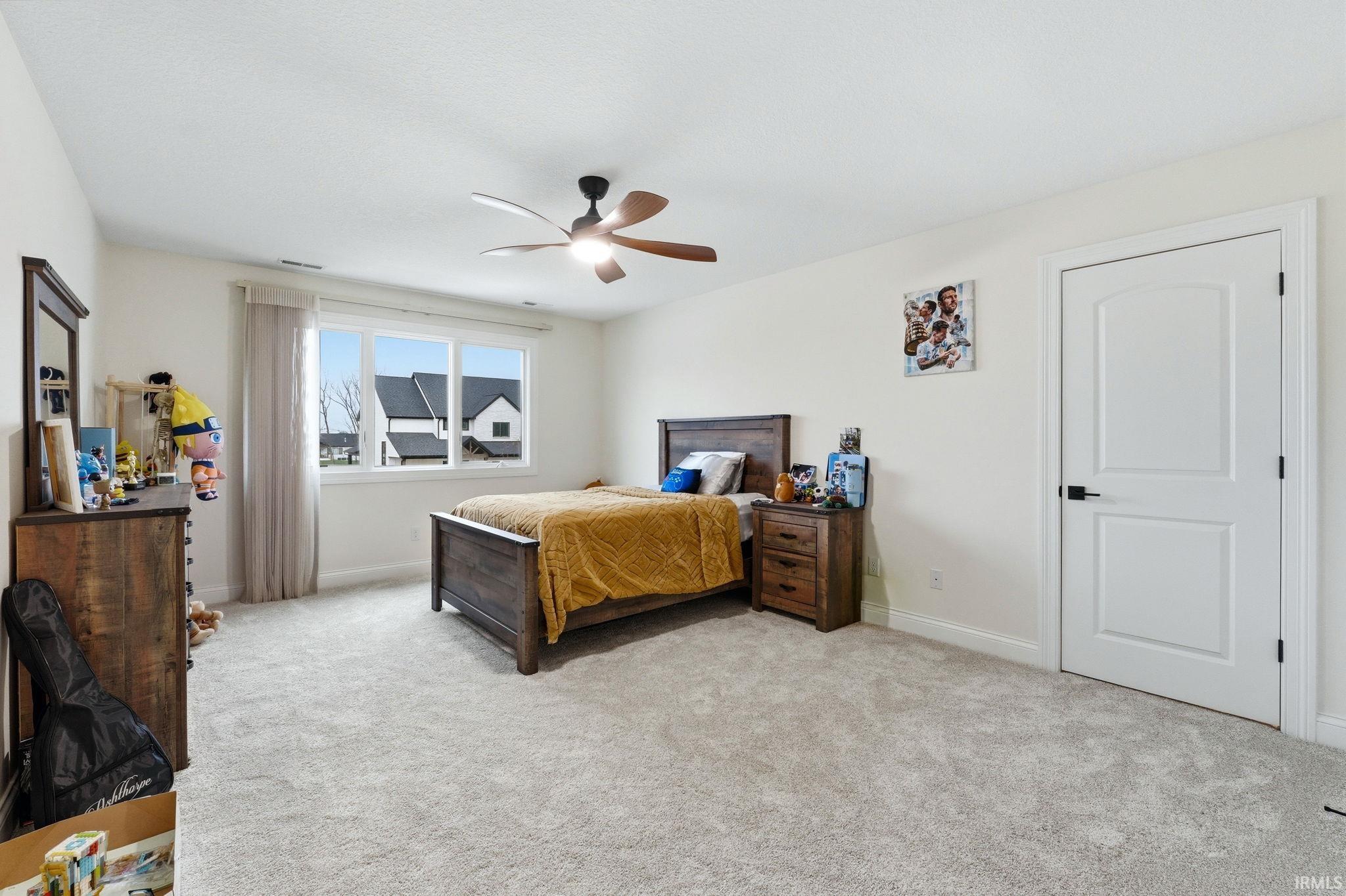Bedroom with light carpet and ceiling fan