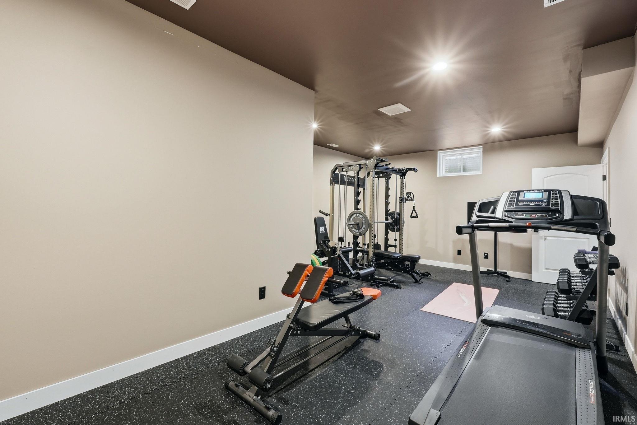 Workout room featuring recessed lighting and rubber floors