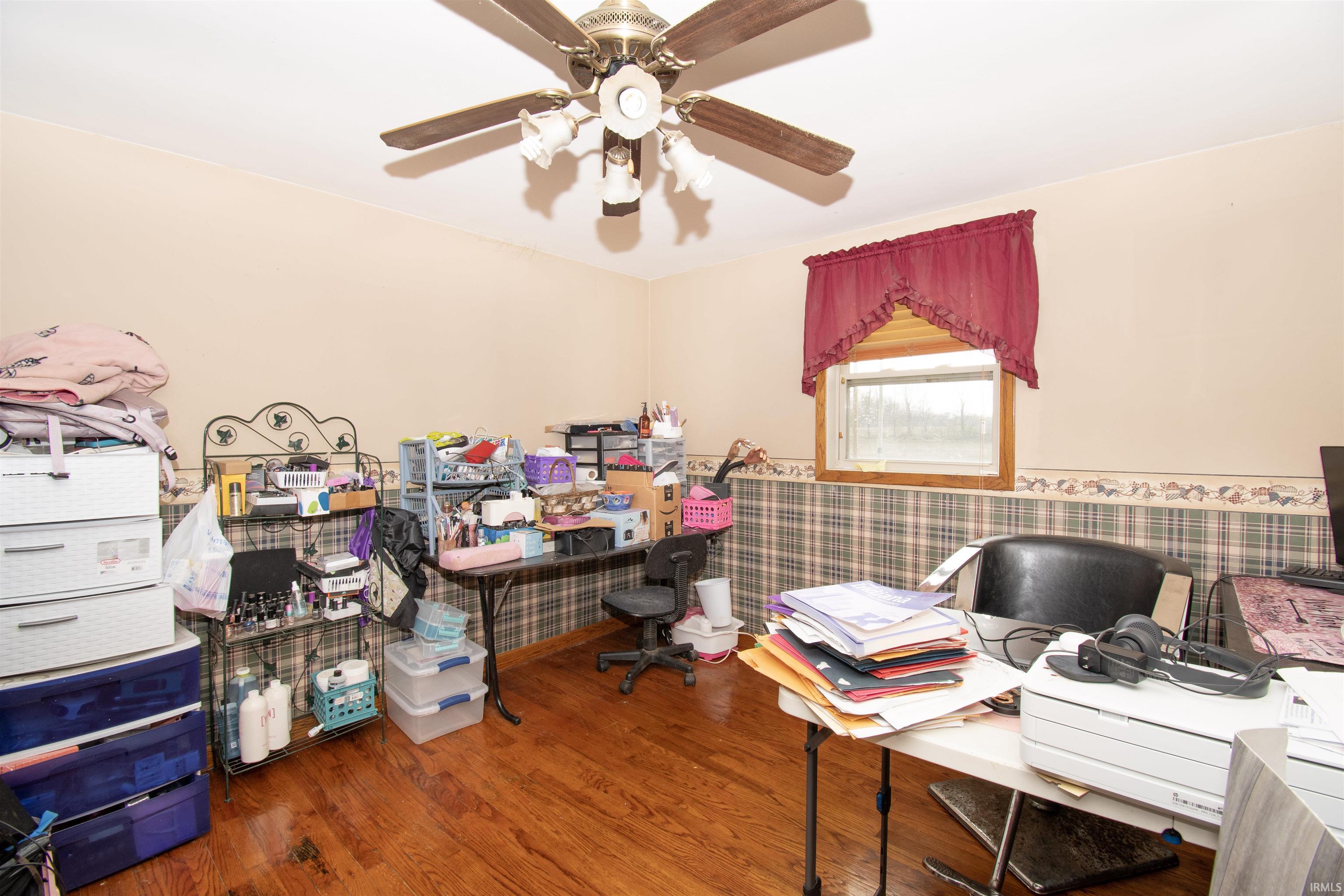 Home office with wood finished floors and ceiling fan