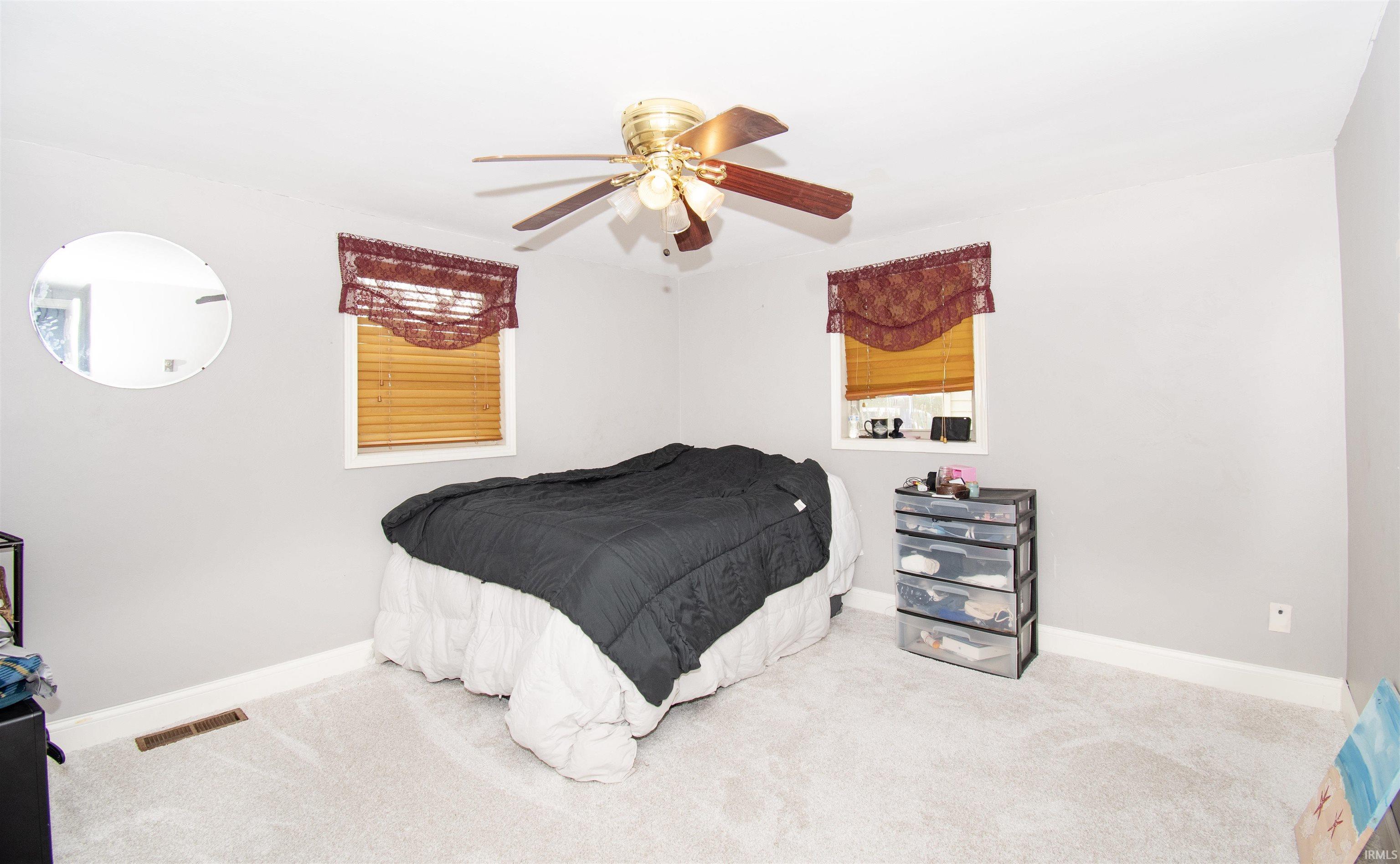 Bedroom featuring carpet floors and ceiling fan