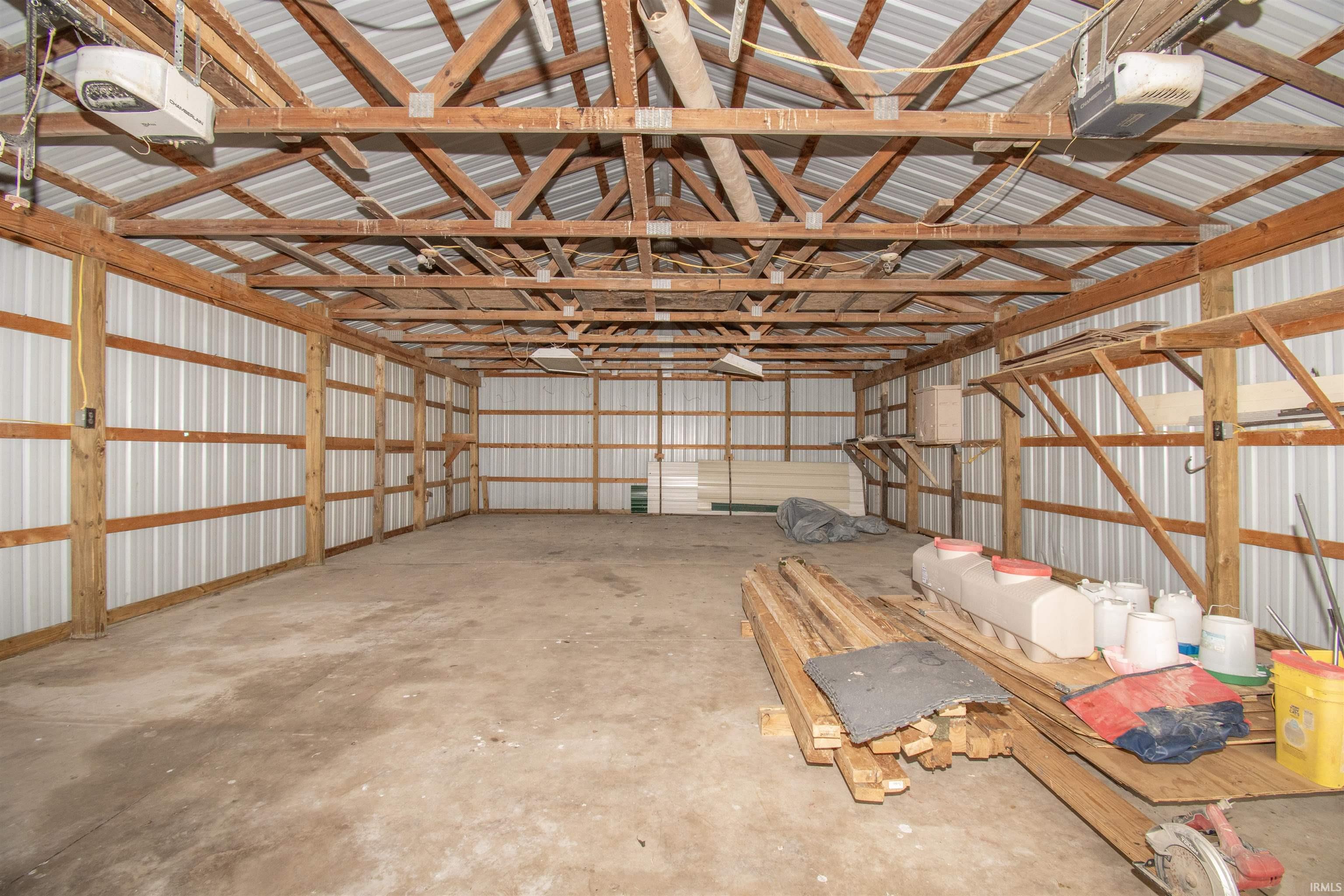 Garage featuring metal wall and a garage door opener
