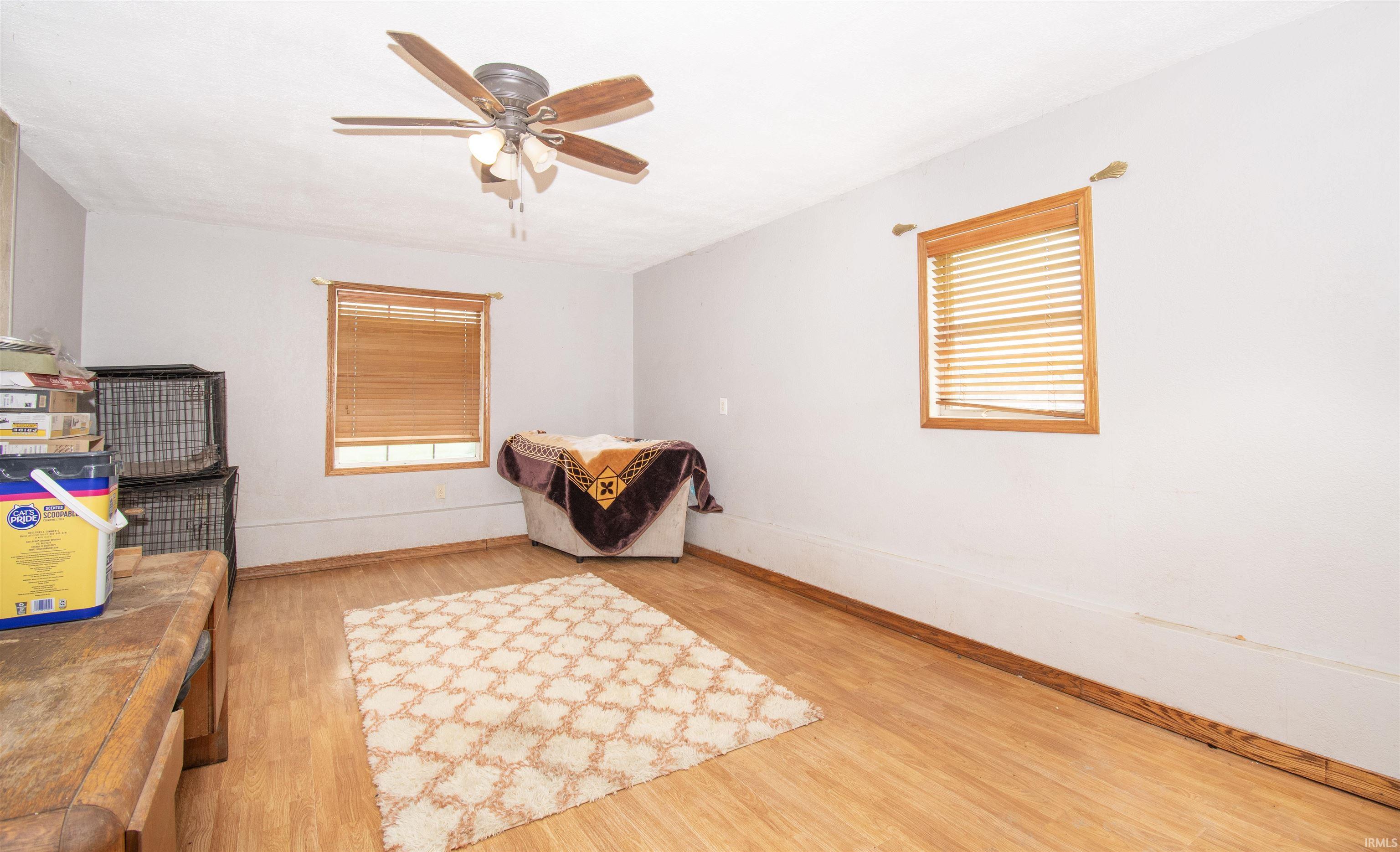 Bedroom featuring light wood-type flooring and a ceiling fan