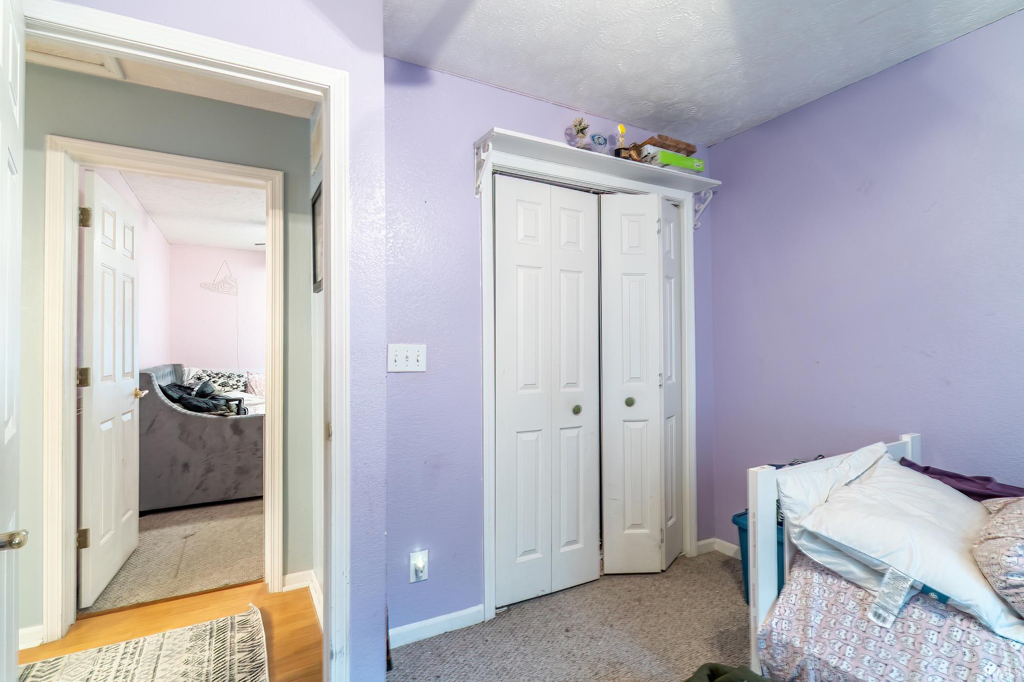 Bedroom featuring a closet and light carpet