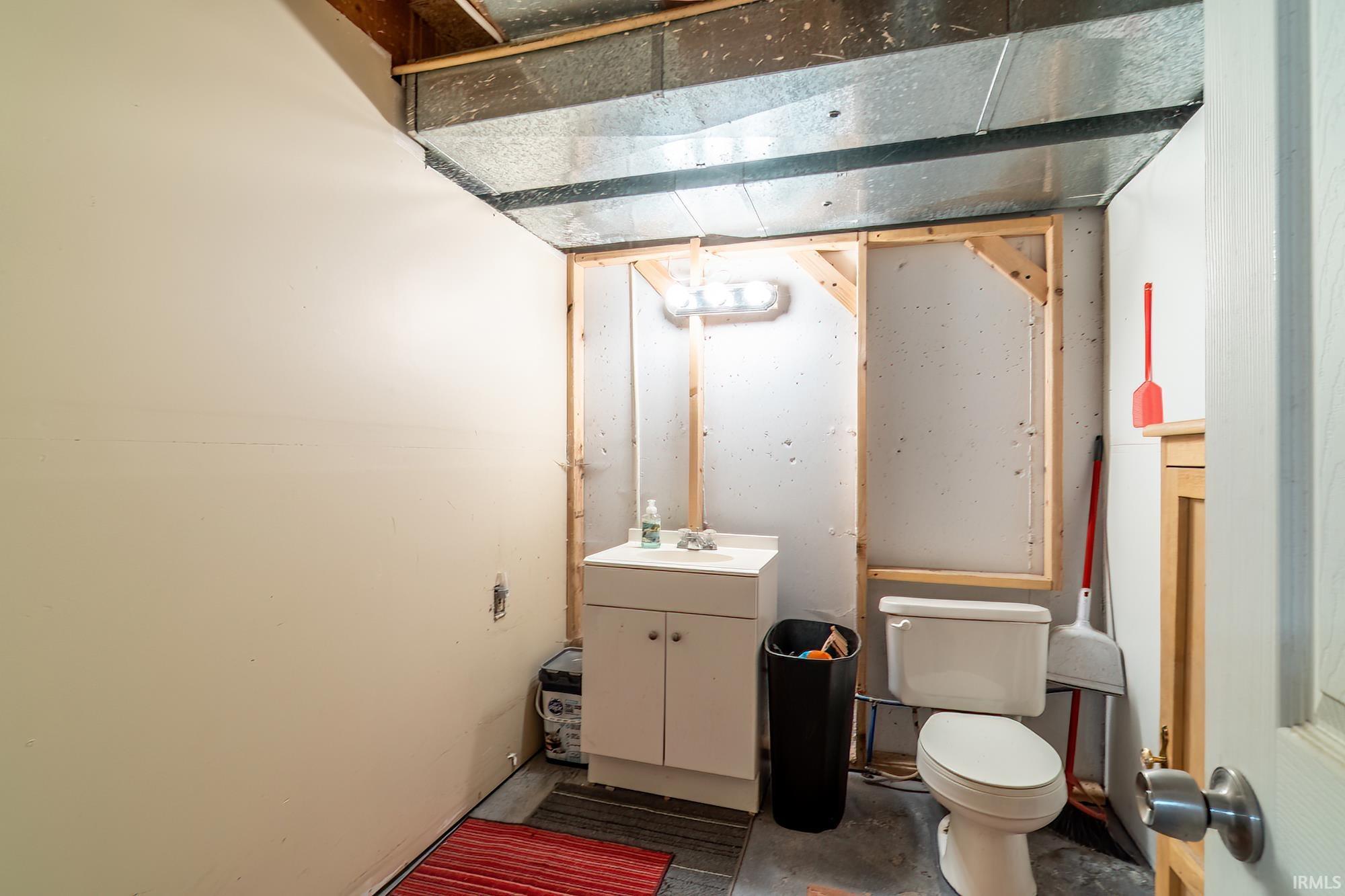 Bathroom featuring vanity and concrete floors