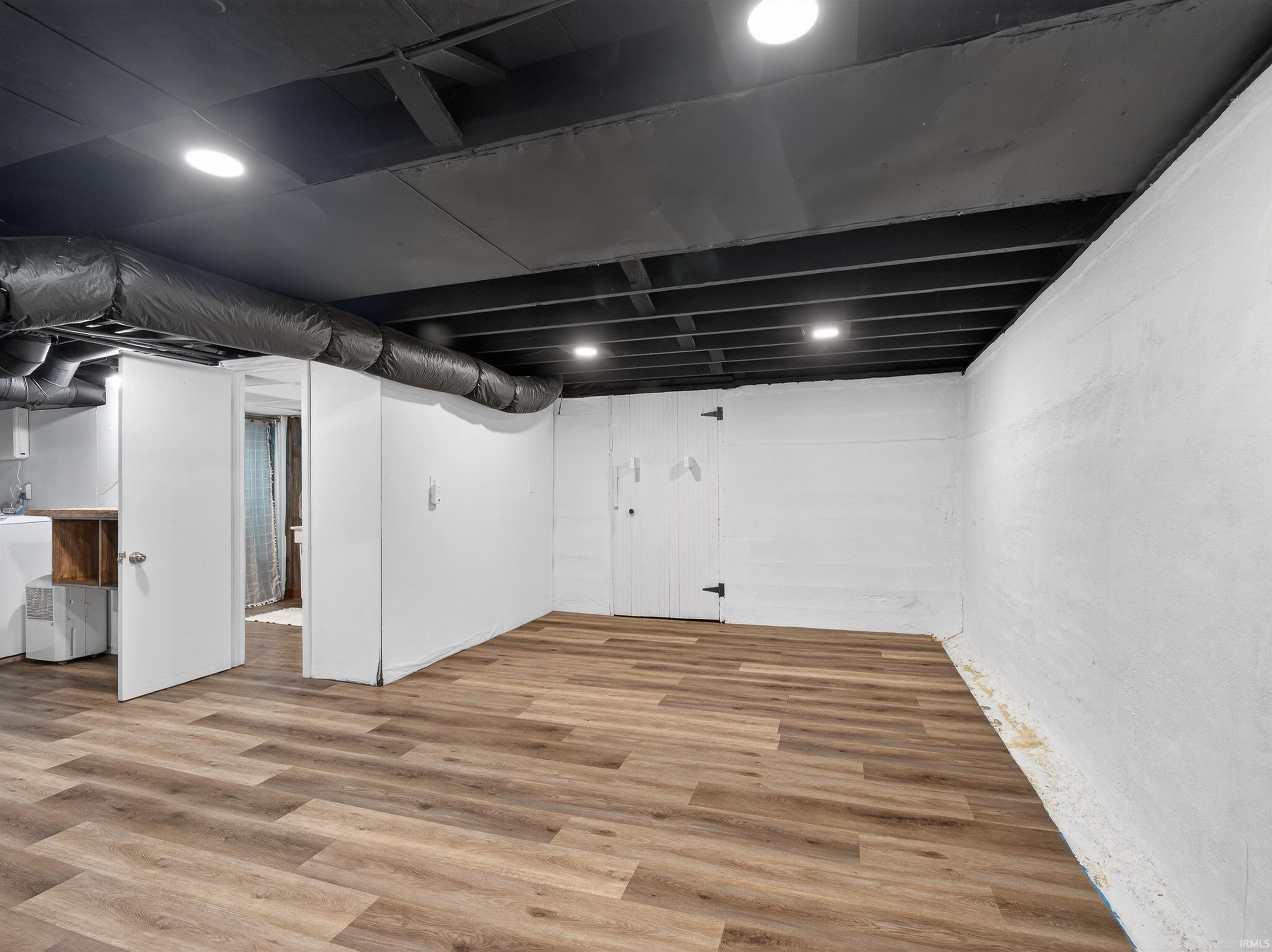 Finished basement featuring light wood-style floors