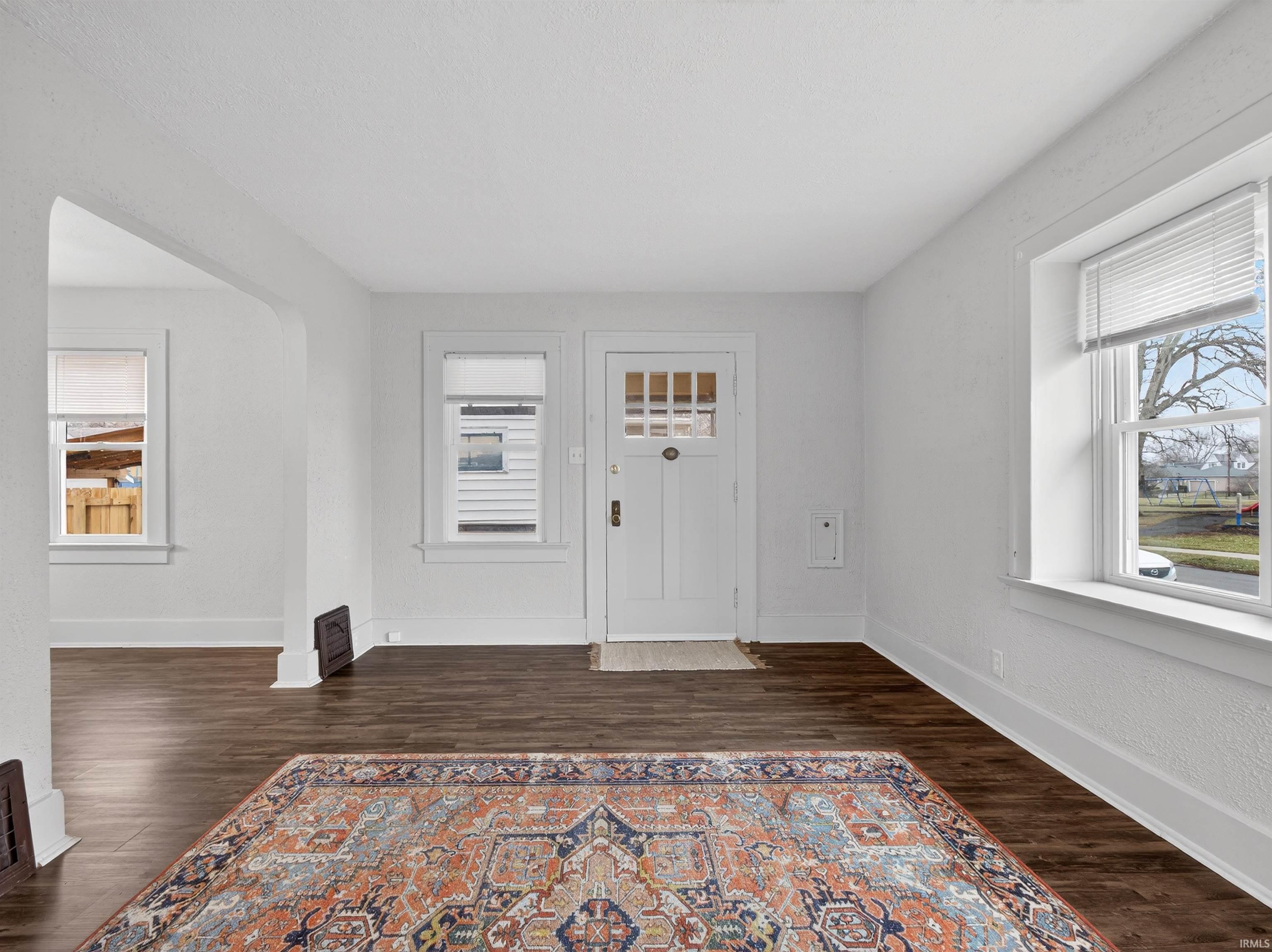 Foyer entrance with dark wood-type flooring