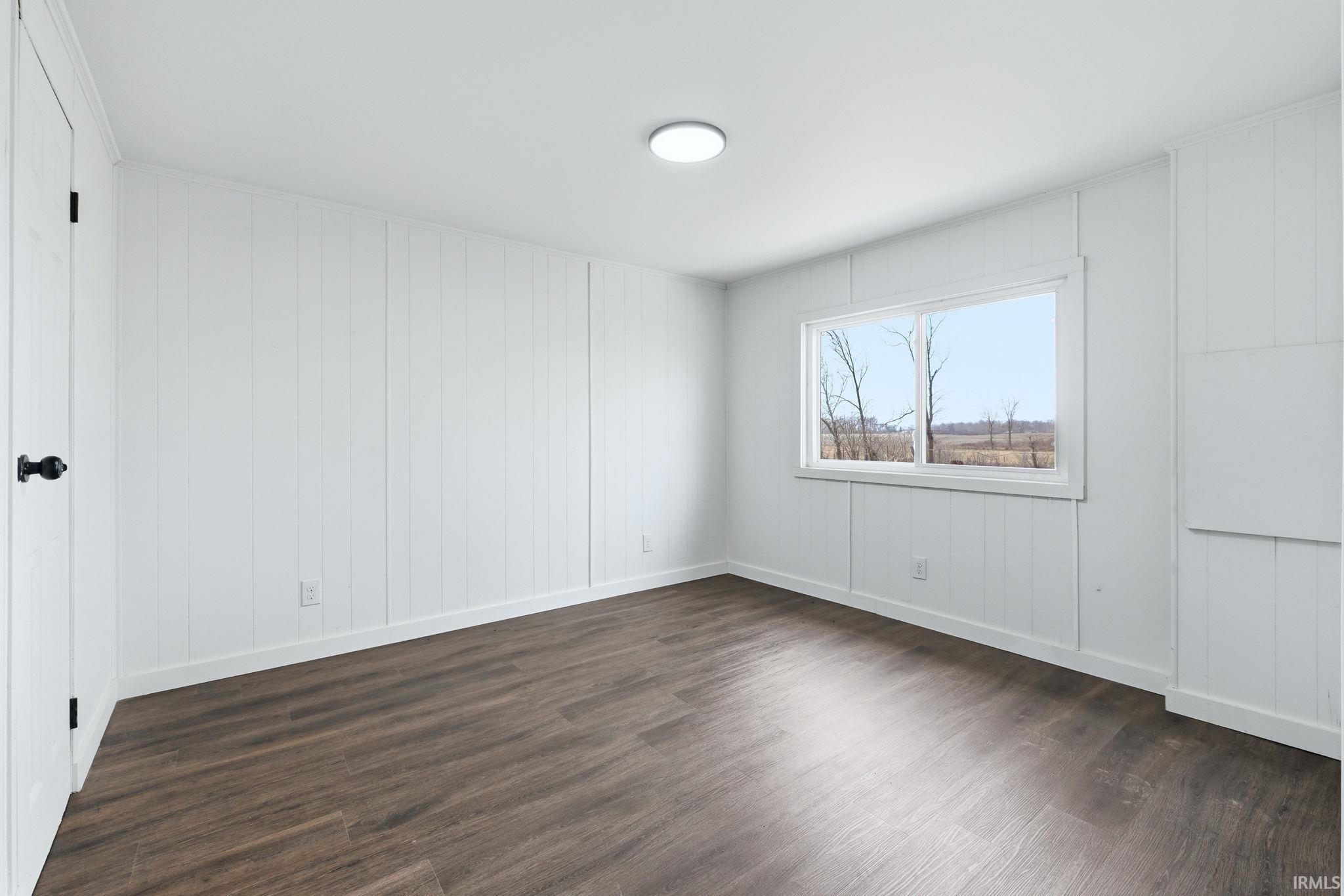 Empty room featuring dark wood finished floors