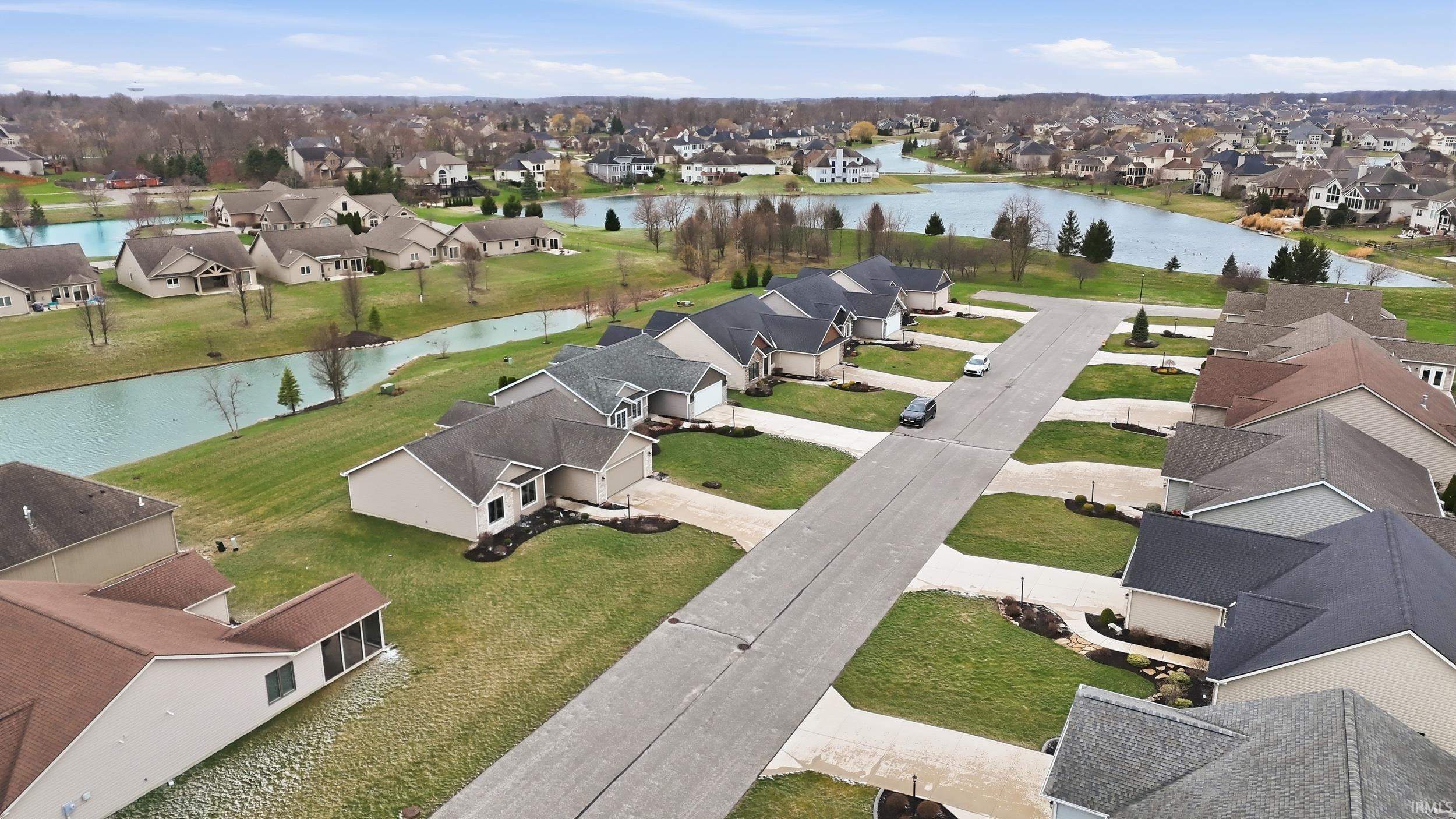 Aerial perspective of suburban area with a nearby body of water