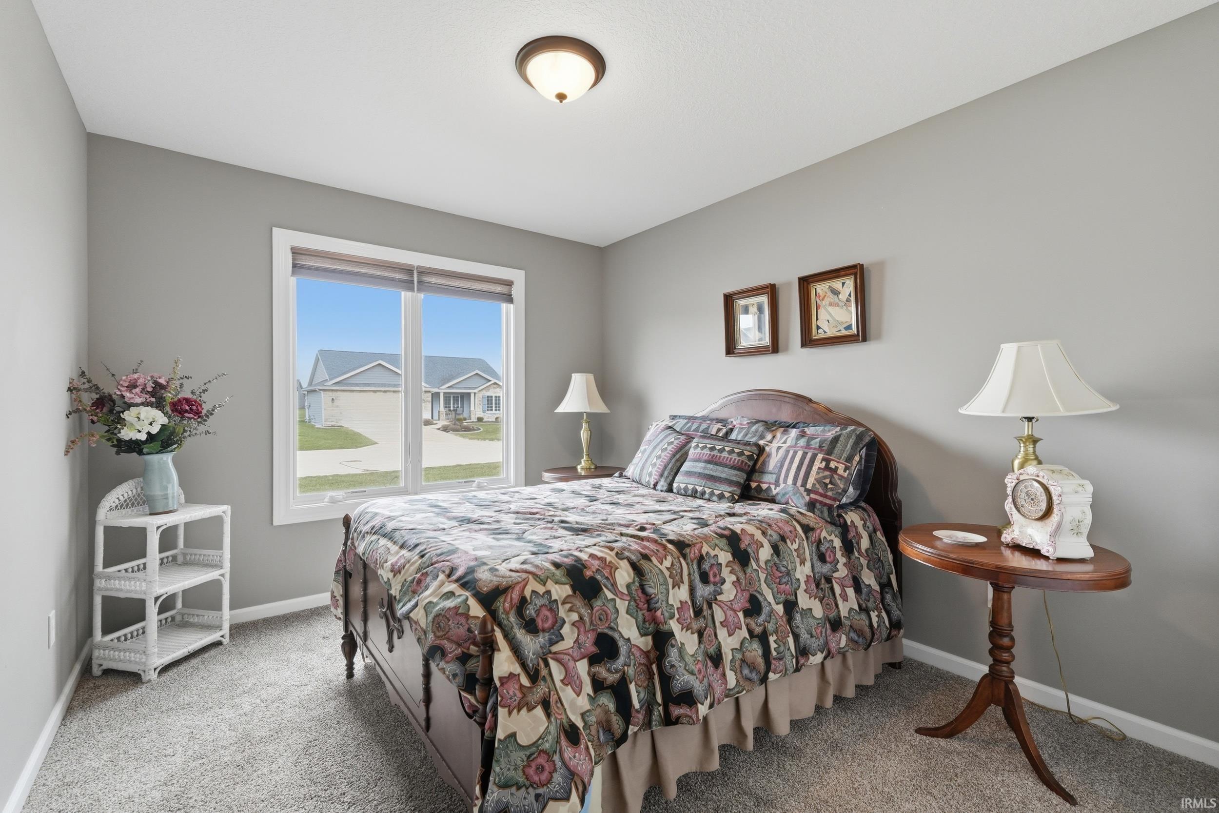Bedroom featuring baseboards and light carpet