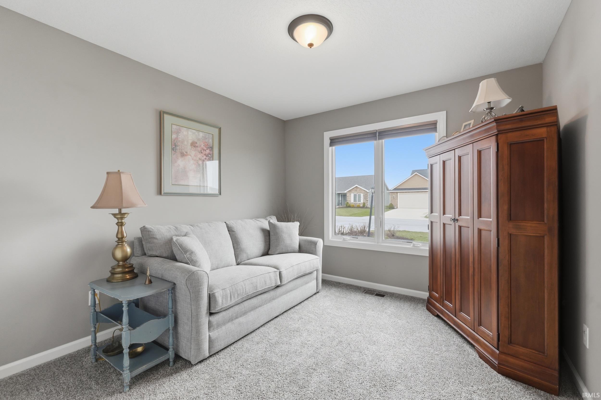 Living area with light carpet