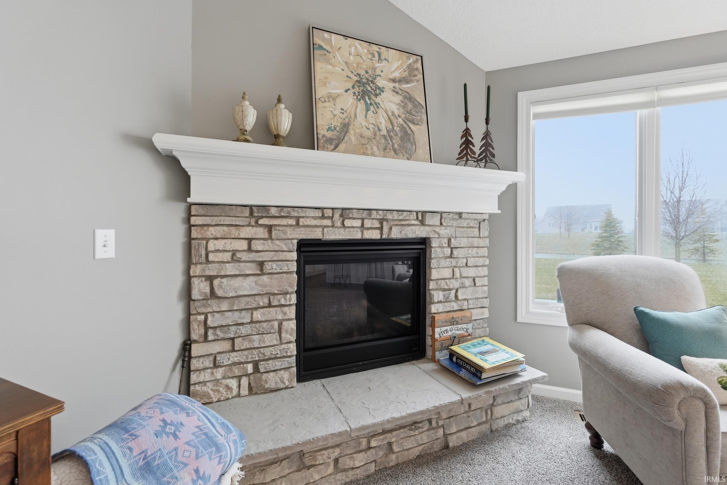 Detailed view of a stone fireplace and carpet