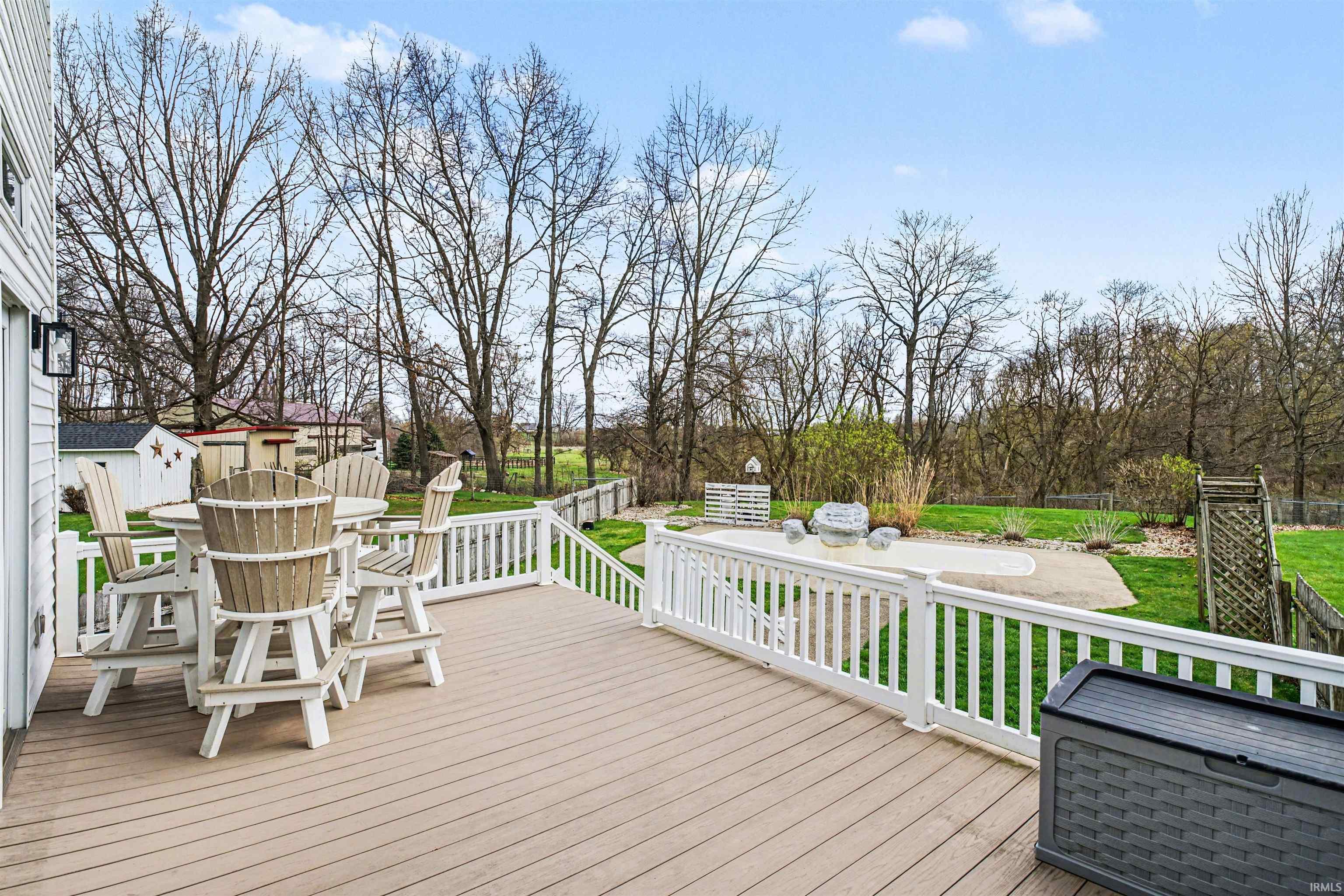 Wooden terrace featuring outdoor dining area and a fenced backyard