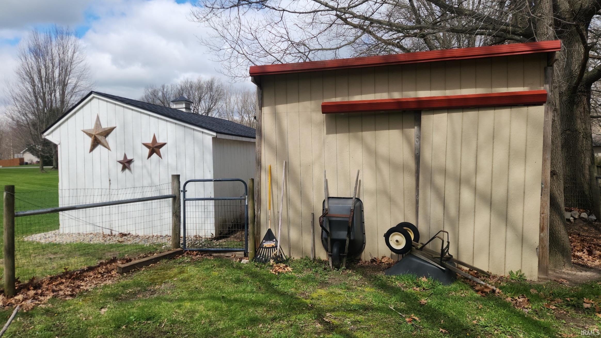 View of outbuilding featuring a gate