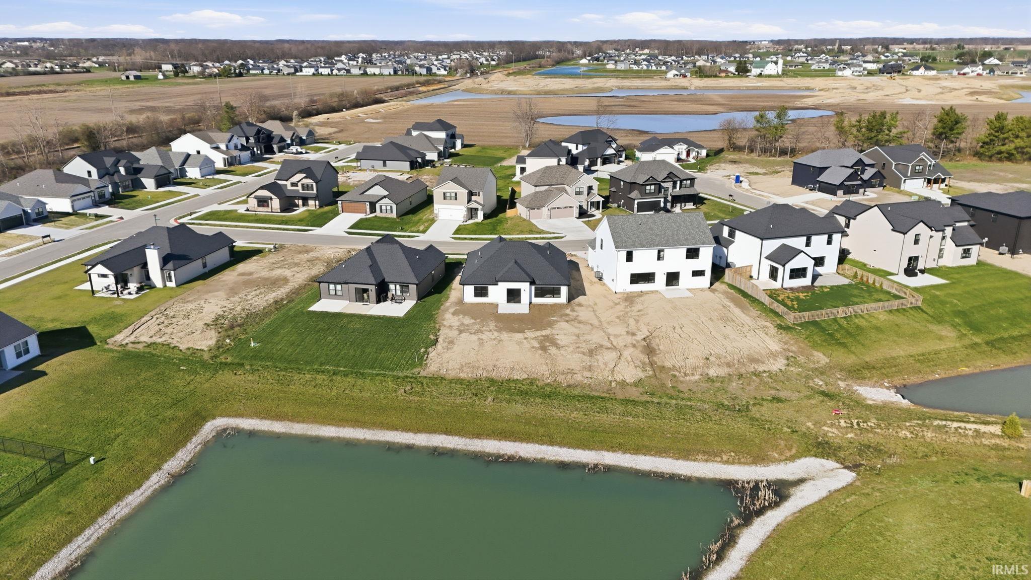 Aerial perspective of suburban area with a large body of water
