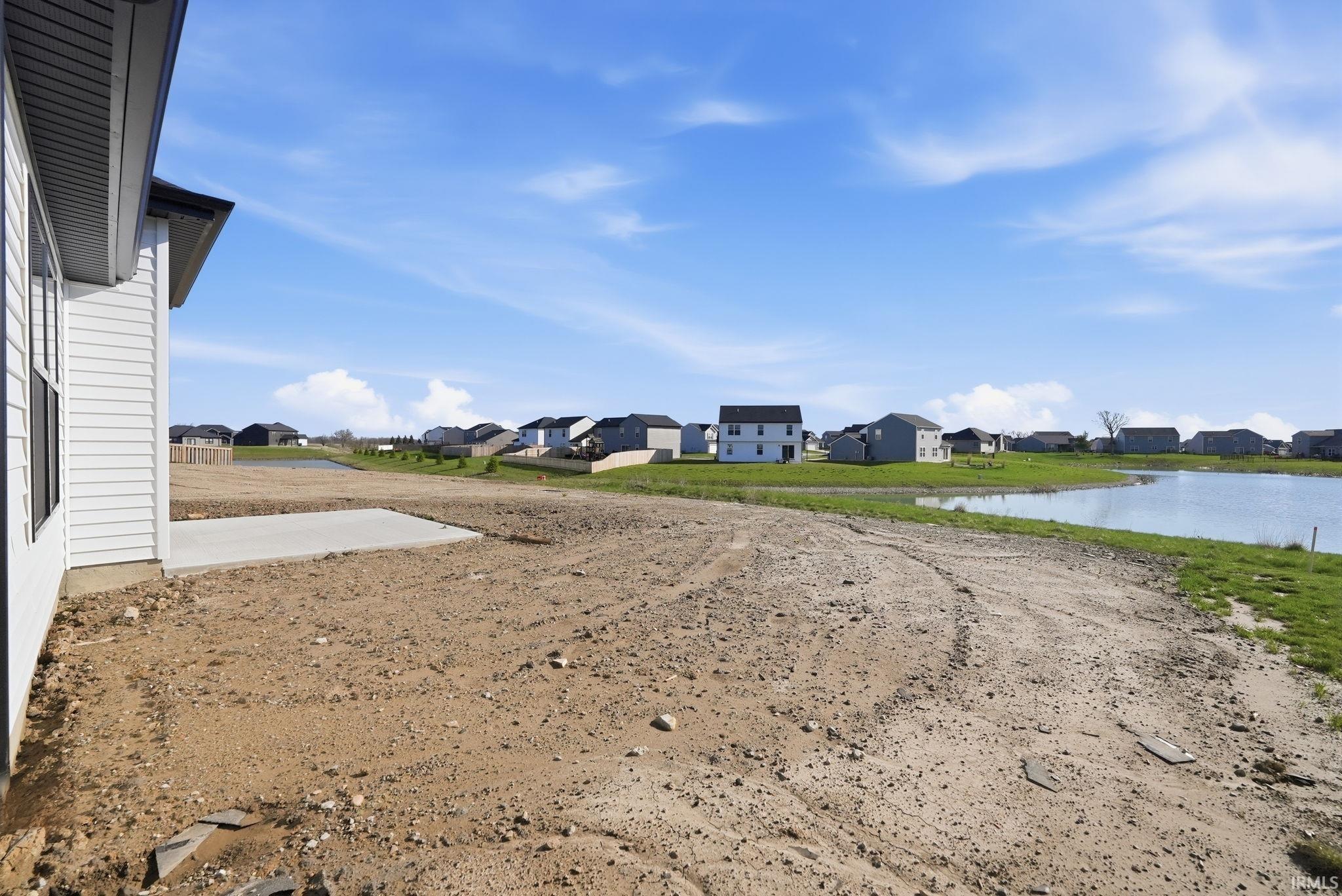 View of yard with a residential view and a water view