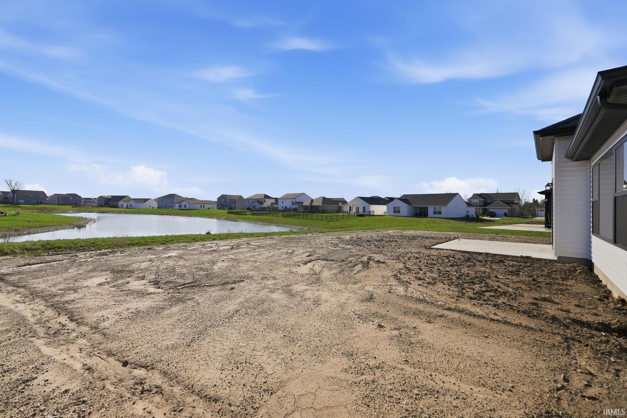View of yard featuring a residential view and a water view