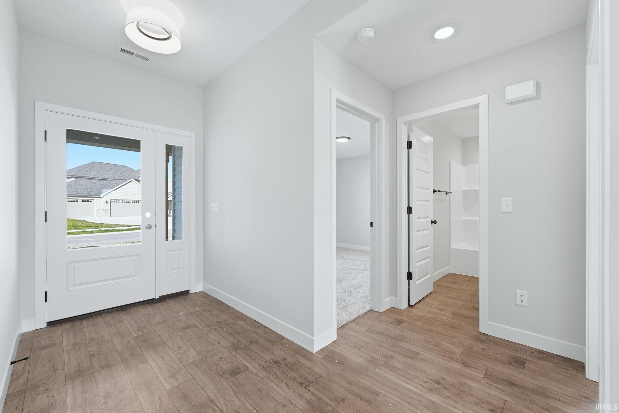 Entrance foyer featuring light wood-style flooring and baseboards