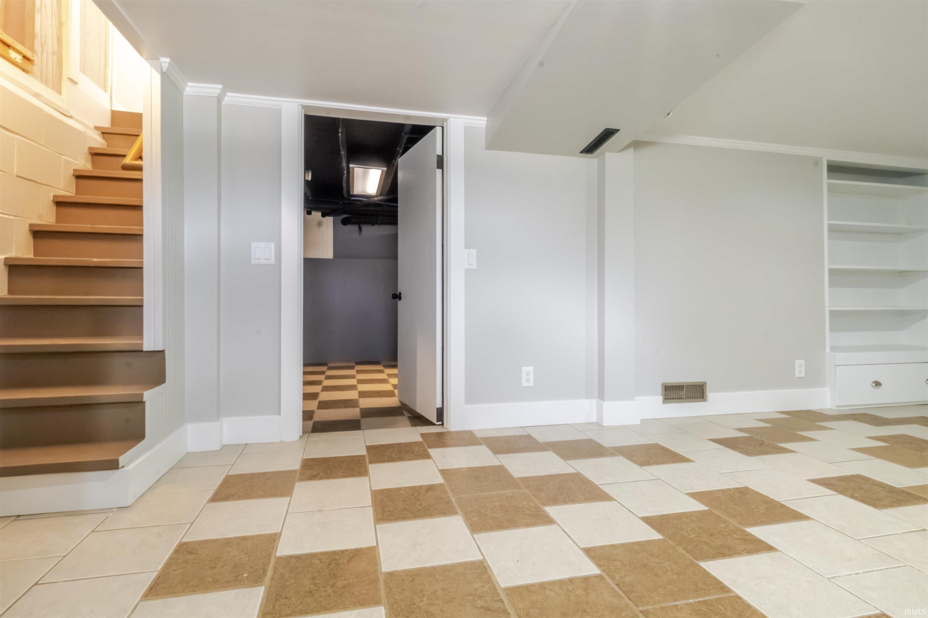 Below grade area with stairs and baseboards