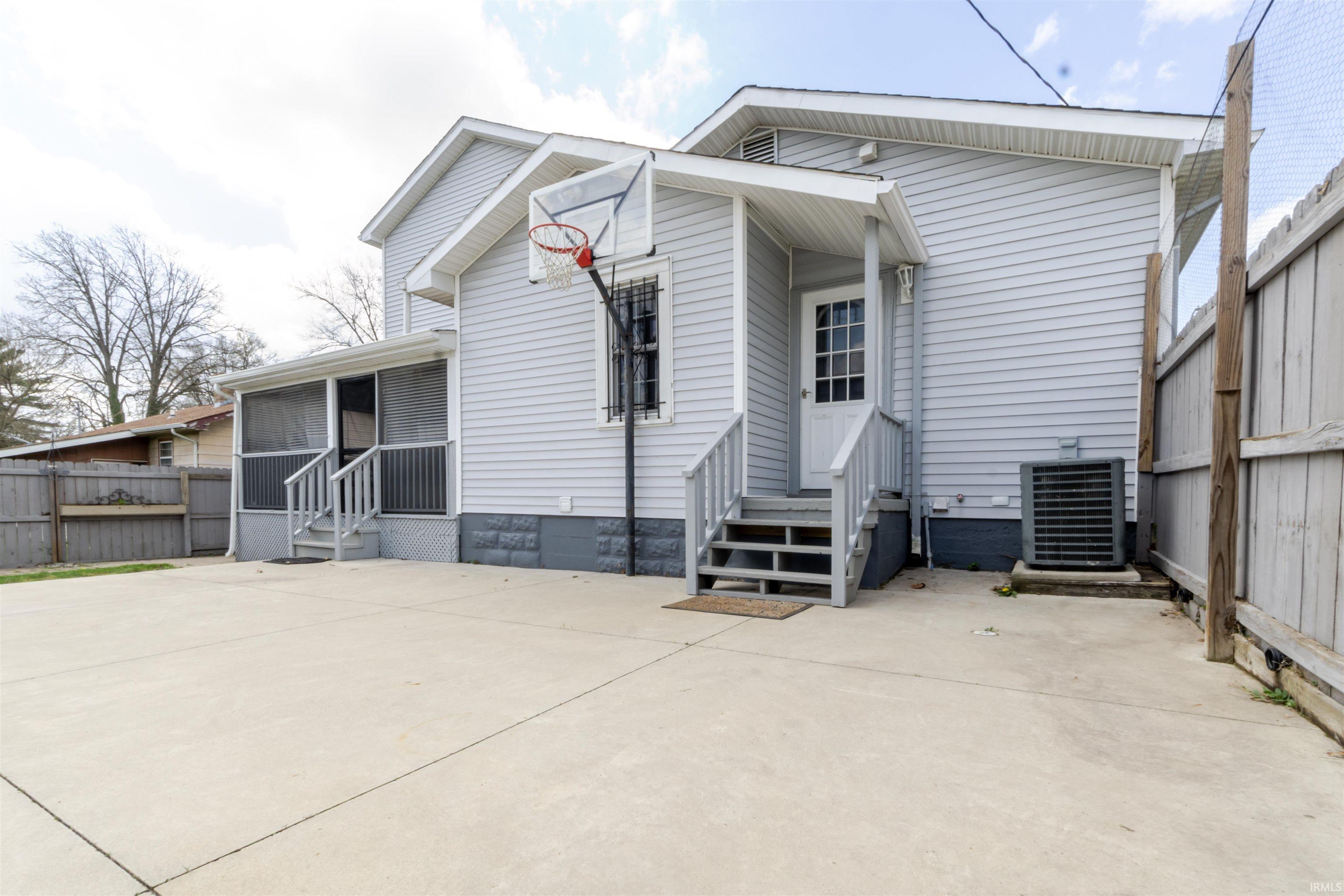 Back of property with entry steps and crawl space