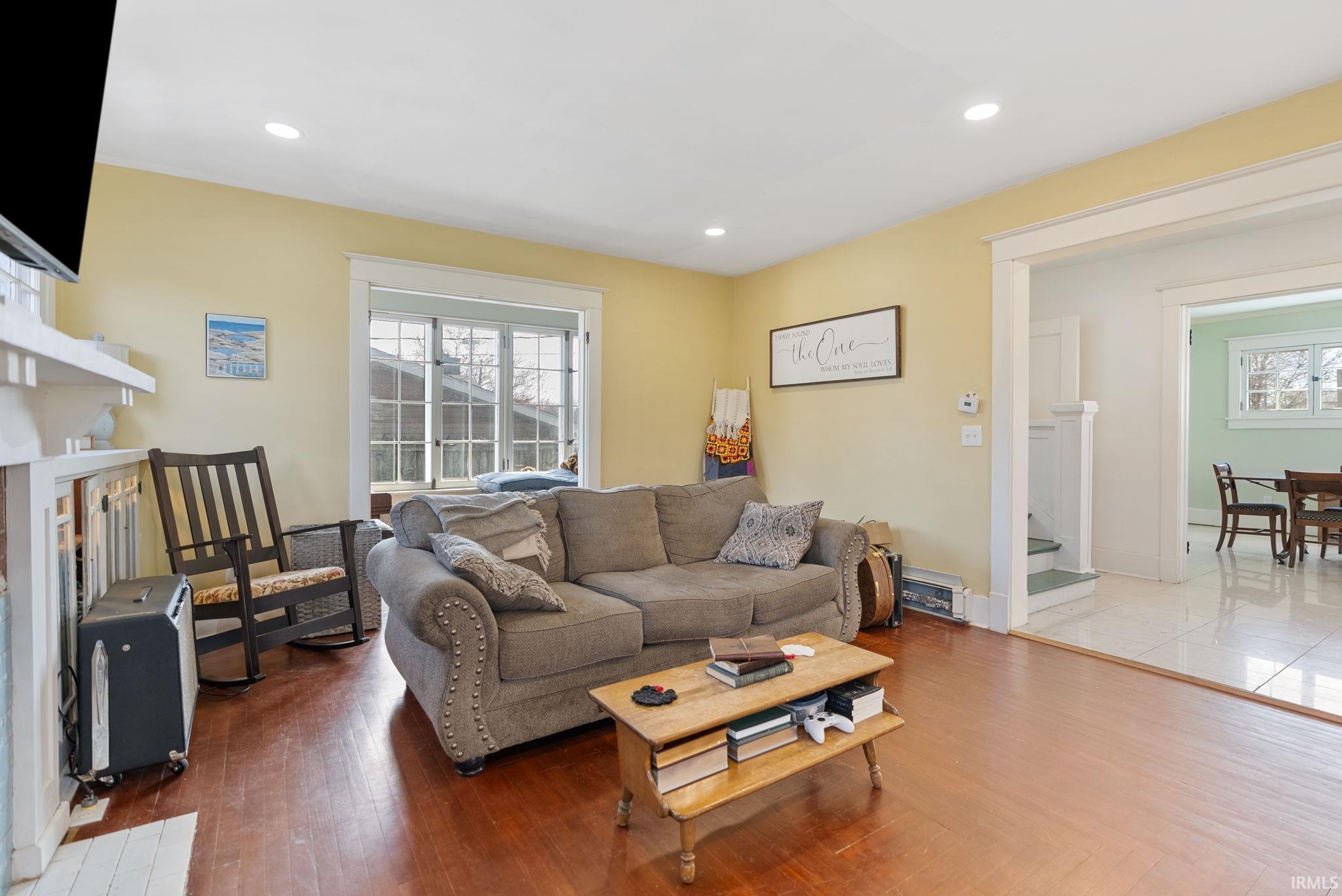 Living area featuring a fireplace, wood finished floors, and recessed lighting