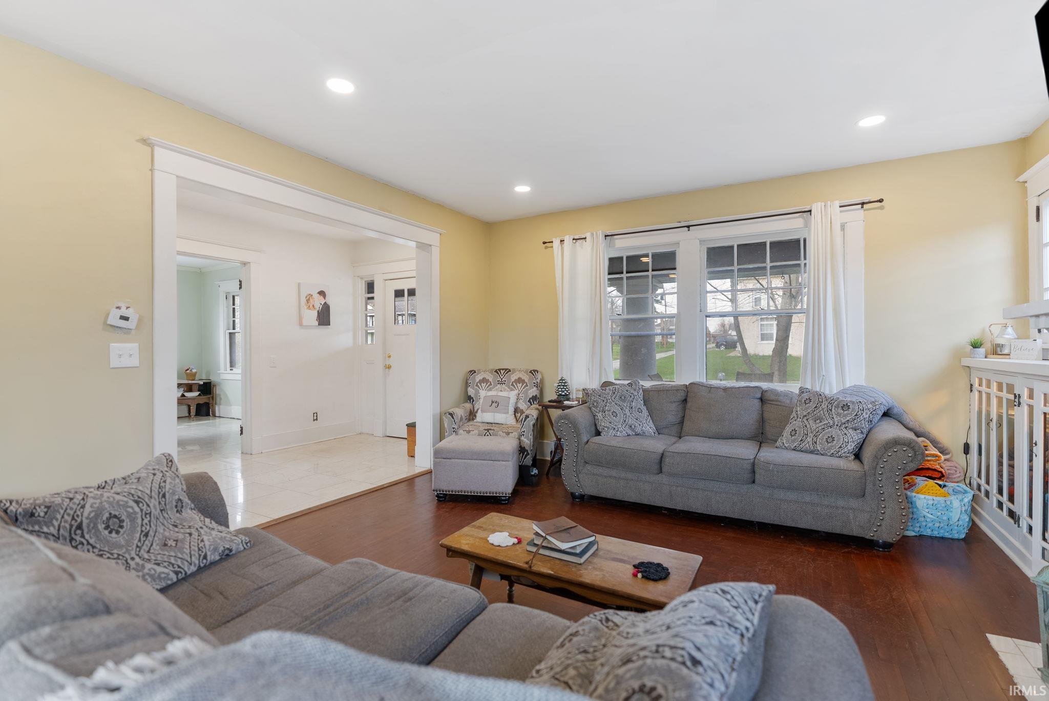 Living room with wood finished floors and recessed lighting
